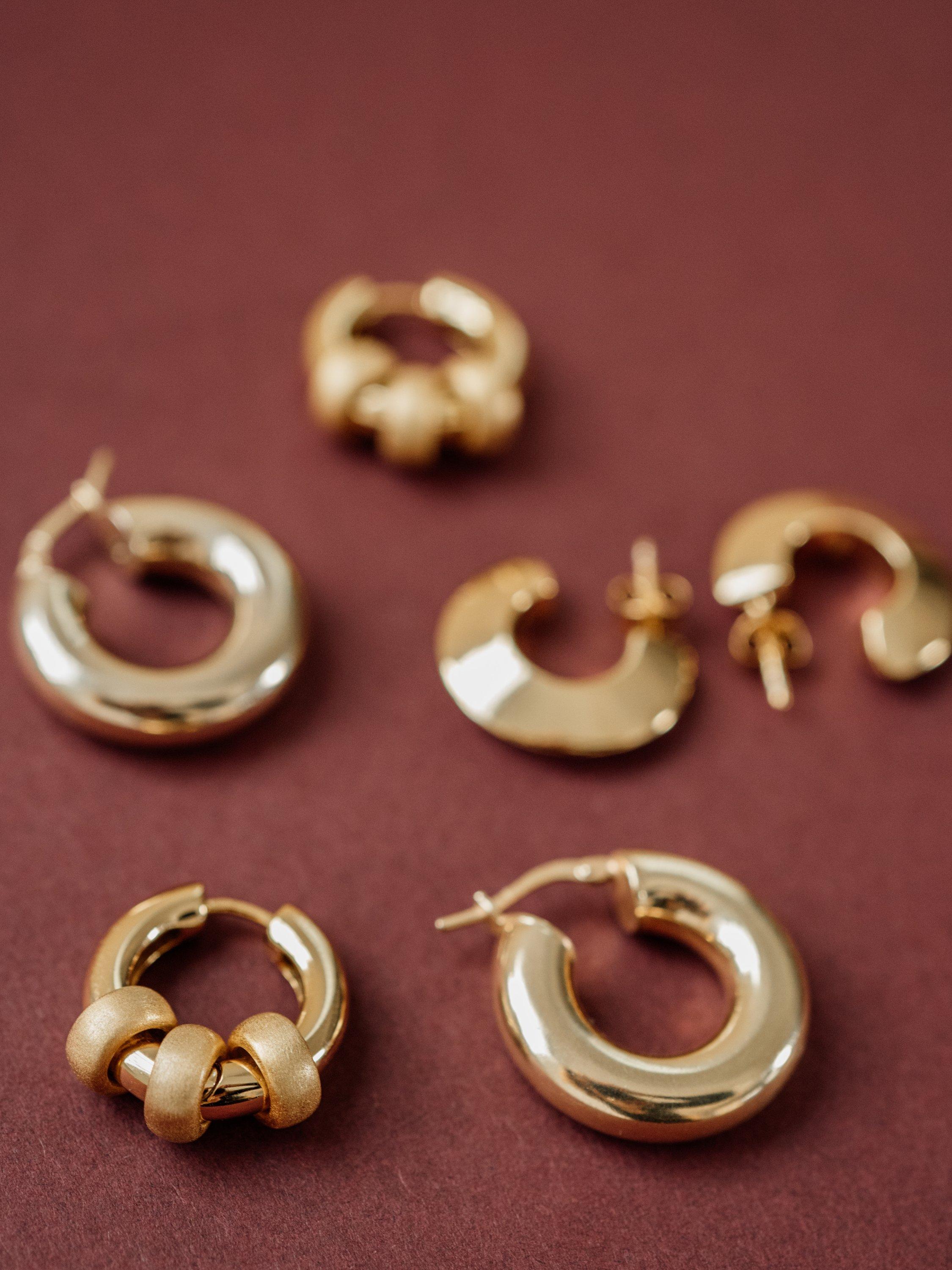 Product image 4 of 5, which shows LARNAUTI Polished and Sand Blasted Hoop Earrings, Gold