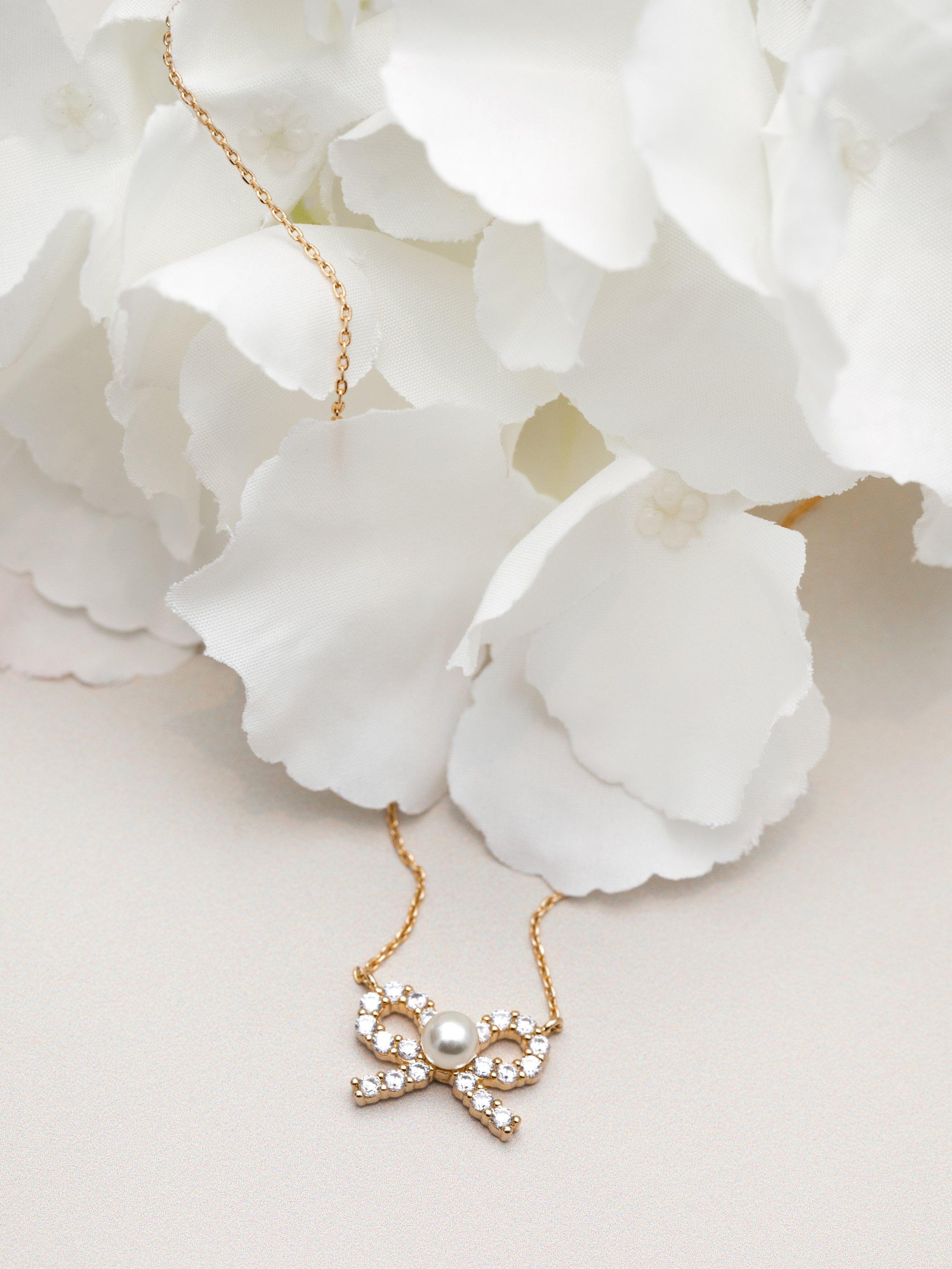 Product image 5 of 5, which shows Orelia Pearl & Crystal Bow Charm Necklace, Pale Gold