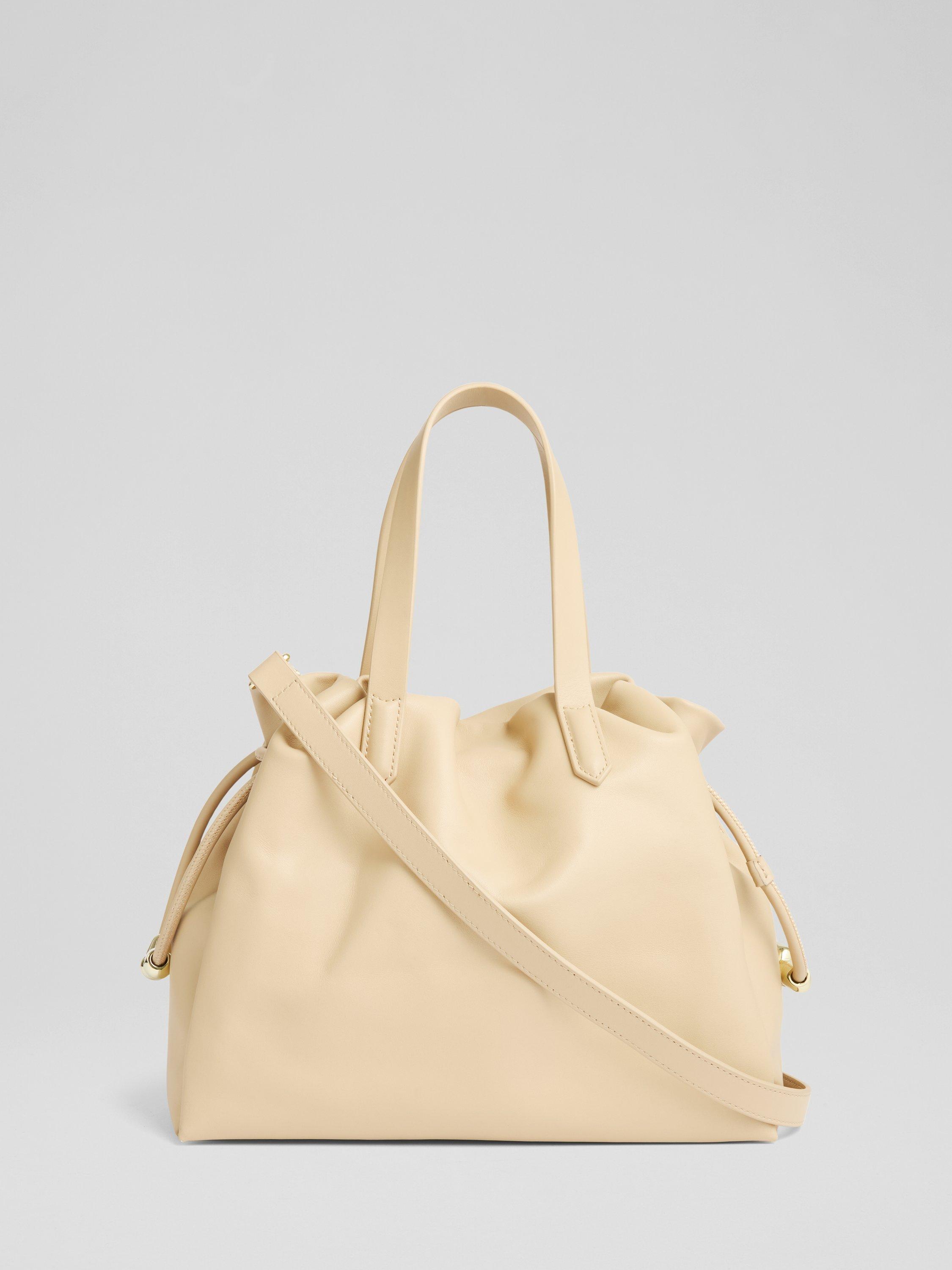 Product image 1 of 3, which shows L.K.Bennett Selina Beaded Drawstring Leather Tote Bag, Light Taupe
