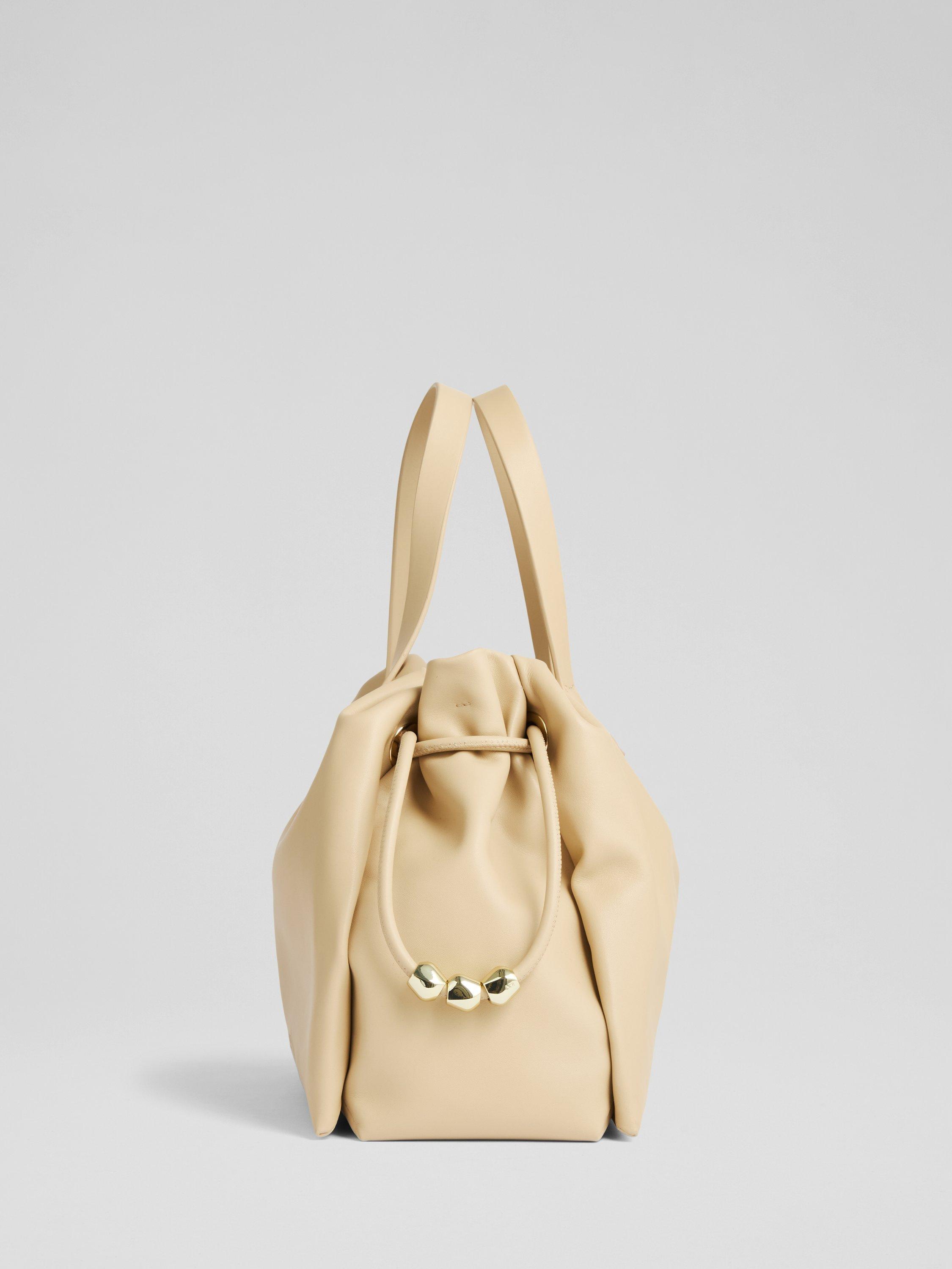 Product image 2 of 3, which shows L.K.Bennett Selina Beaded Drawstring Leather Tote Bag, Light Taupe