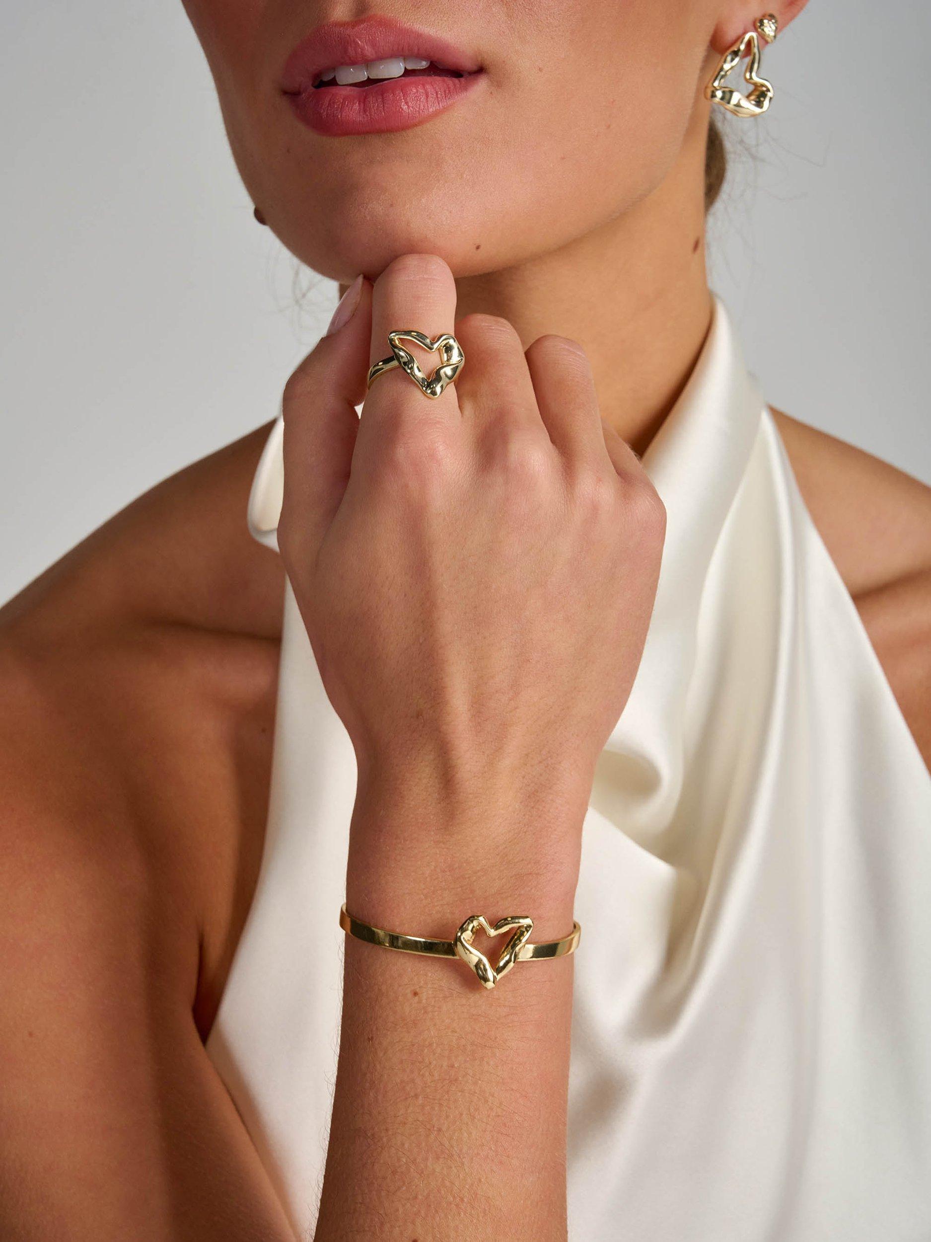 Product image 2 of 5, which shows Tutti & Co Moment Twisted Heart Bangle, Gold