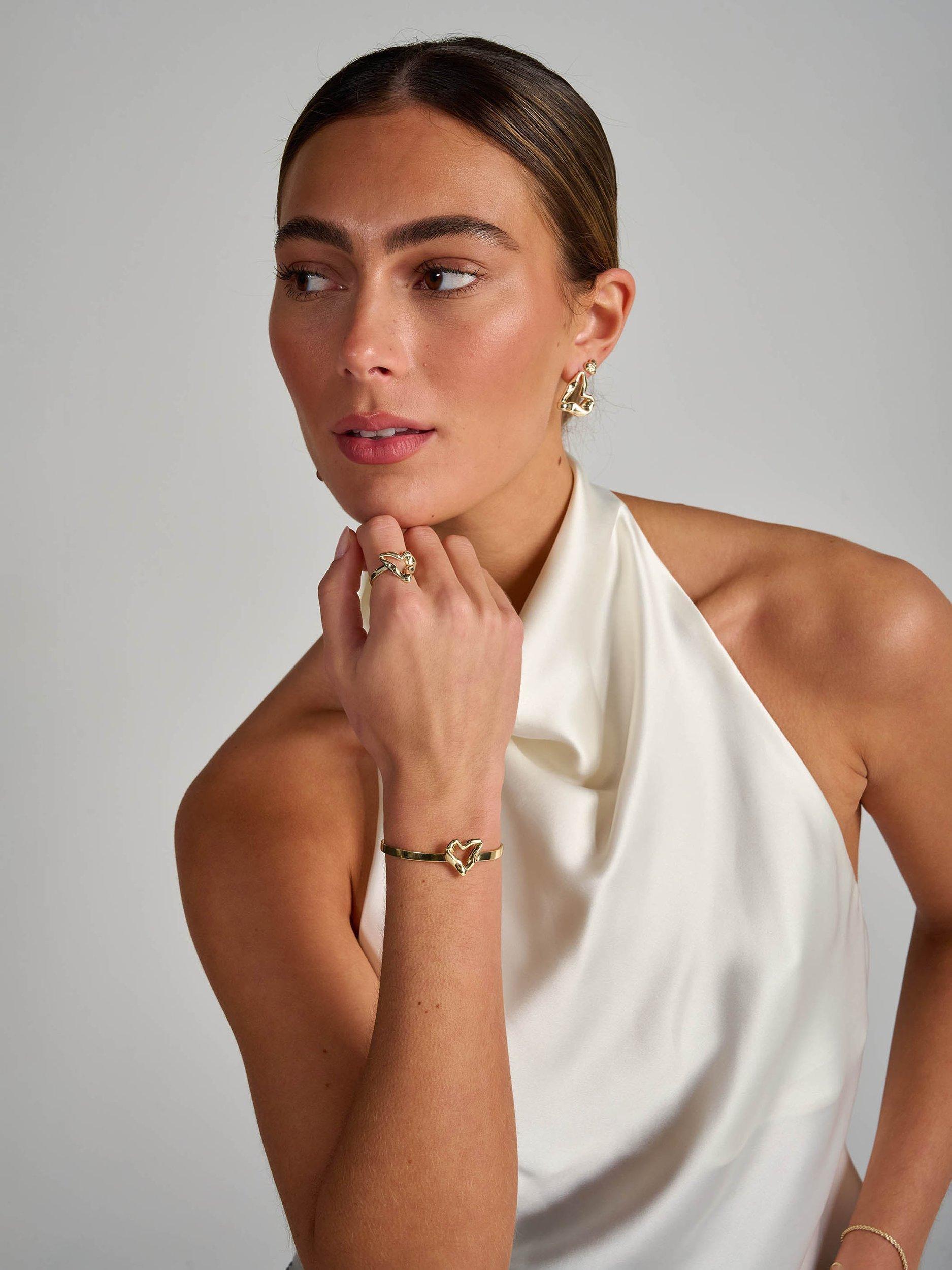 Product image 4 of 5, which shows Tutti & Co Moment Twisted Heart Bangle, Gold