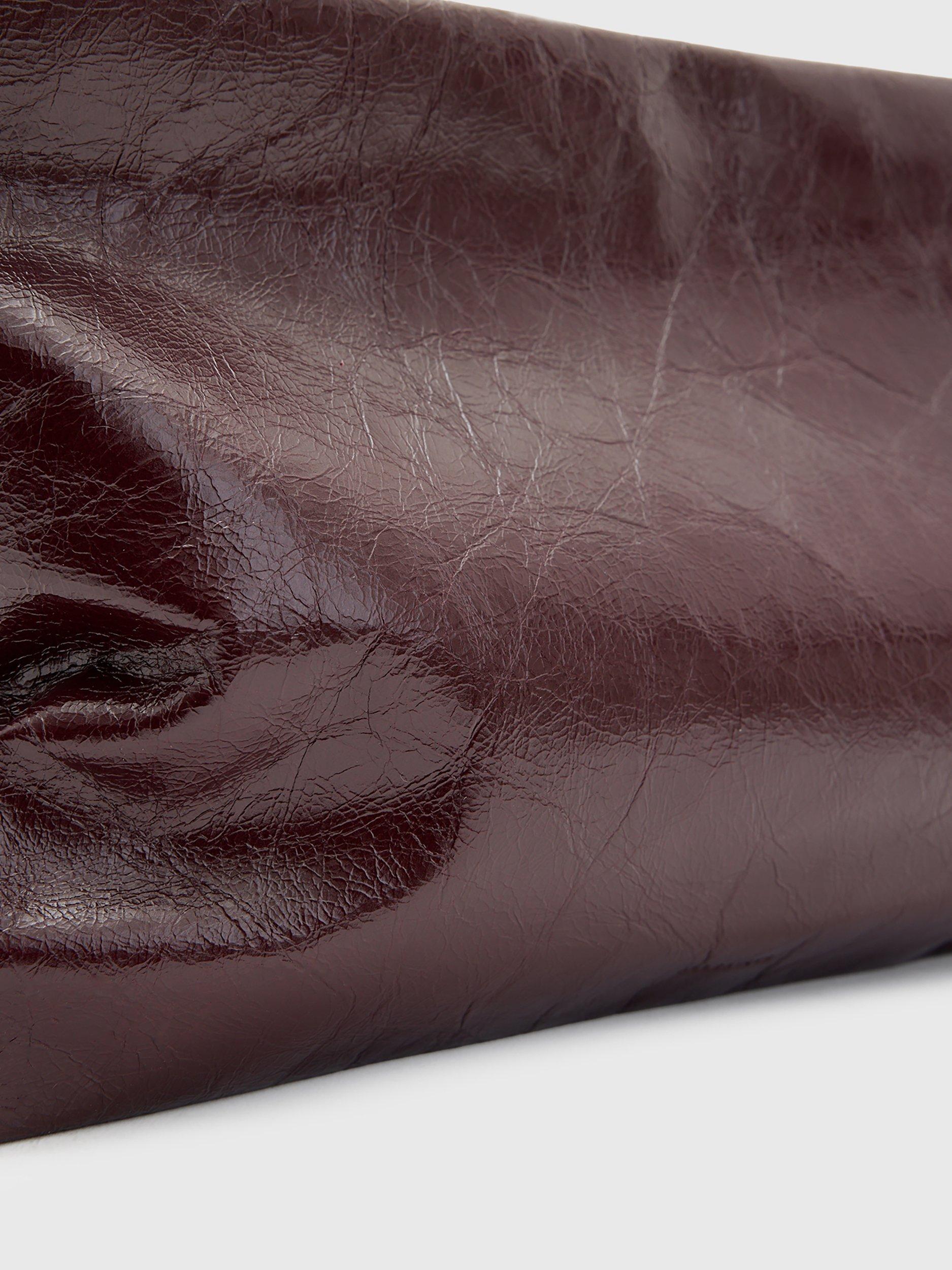 Product image 5 of 6, which shows AllSaints Bettina Leather Clutch Bag, Dark Red