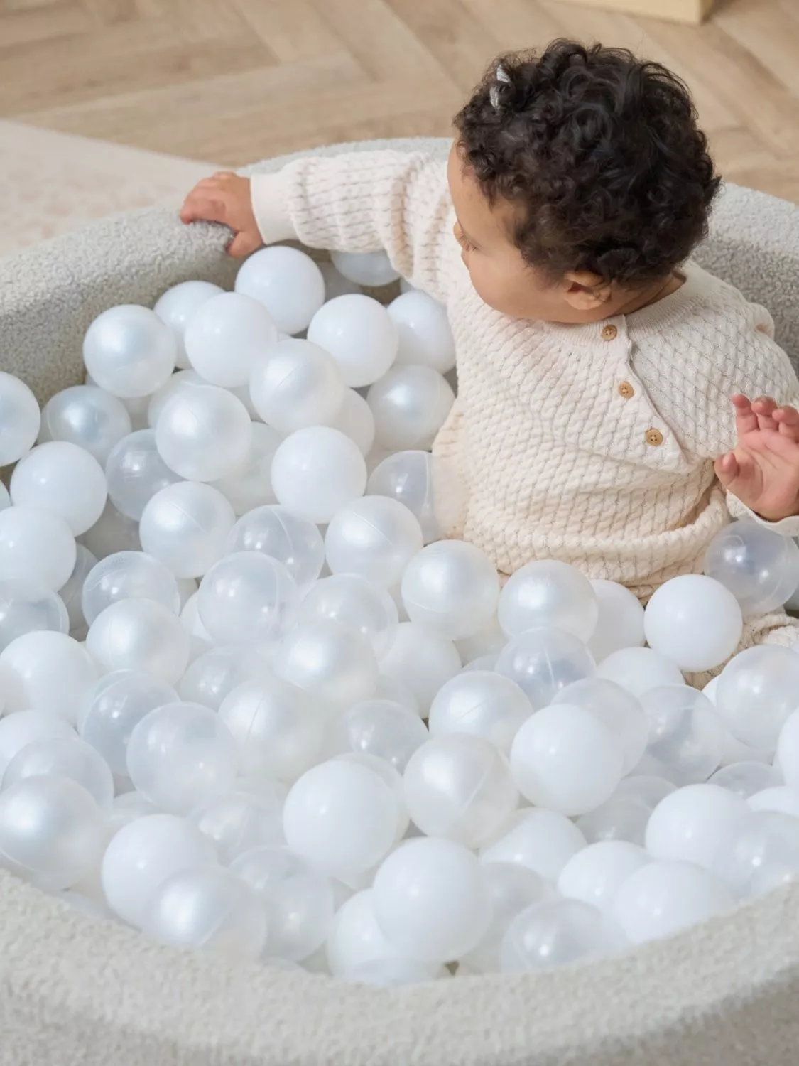 Toddler playing in a ball pit
