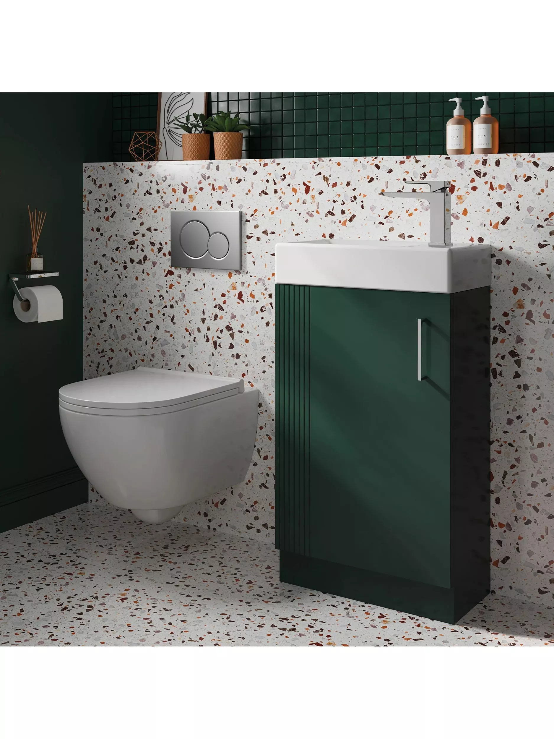 Modern cloakroom with wall-hung toilet, green vanity unit, terrazzo tiles and chrome tap, styled with plants