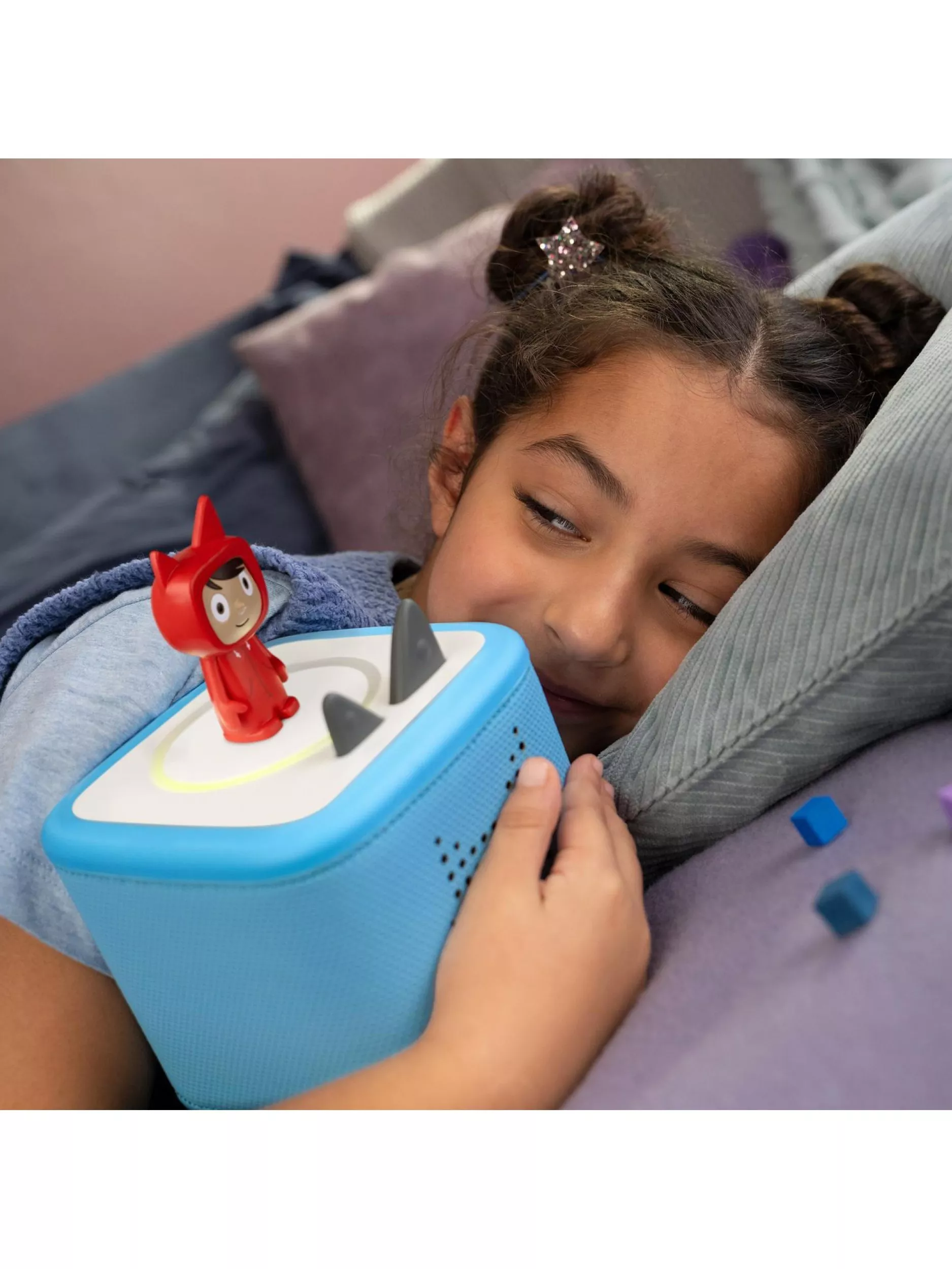 Young girl cuddling her audio player