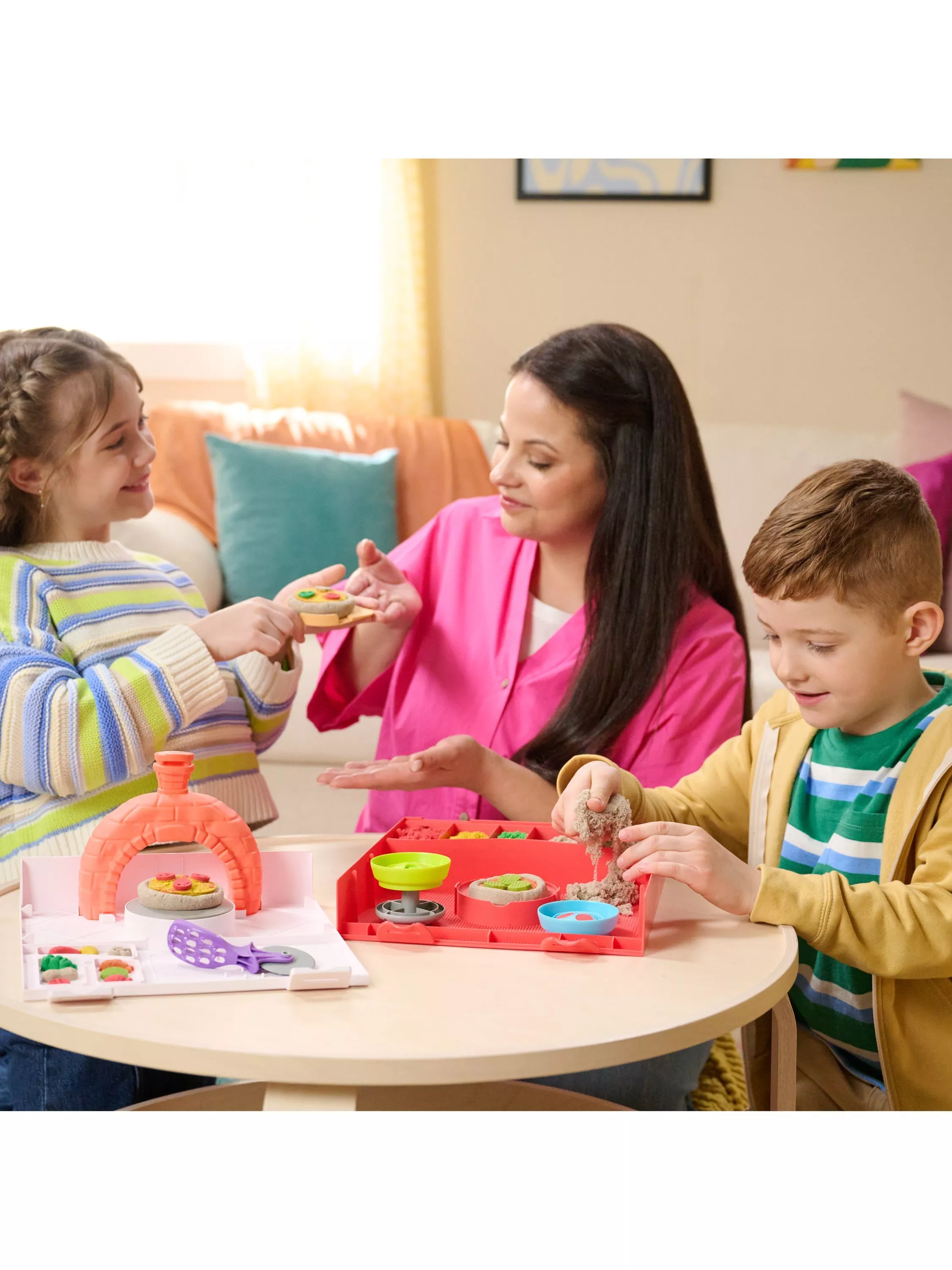 Children and parent playing with a themed pretend pizza making playset