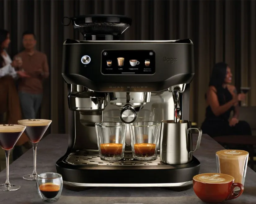 Sage Barista espresso coffee machine pulling double shots, with milk jug and lattes on a home bar counter