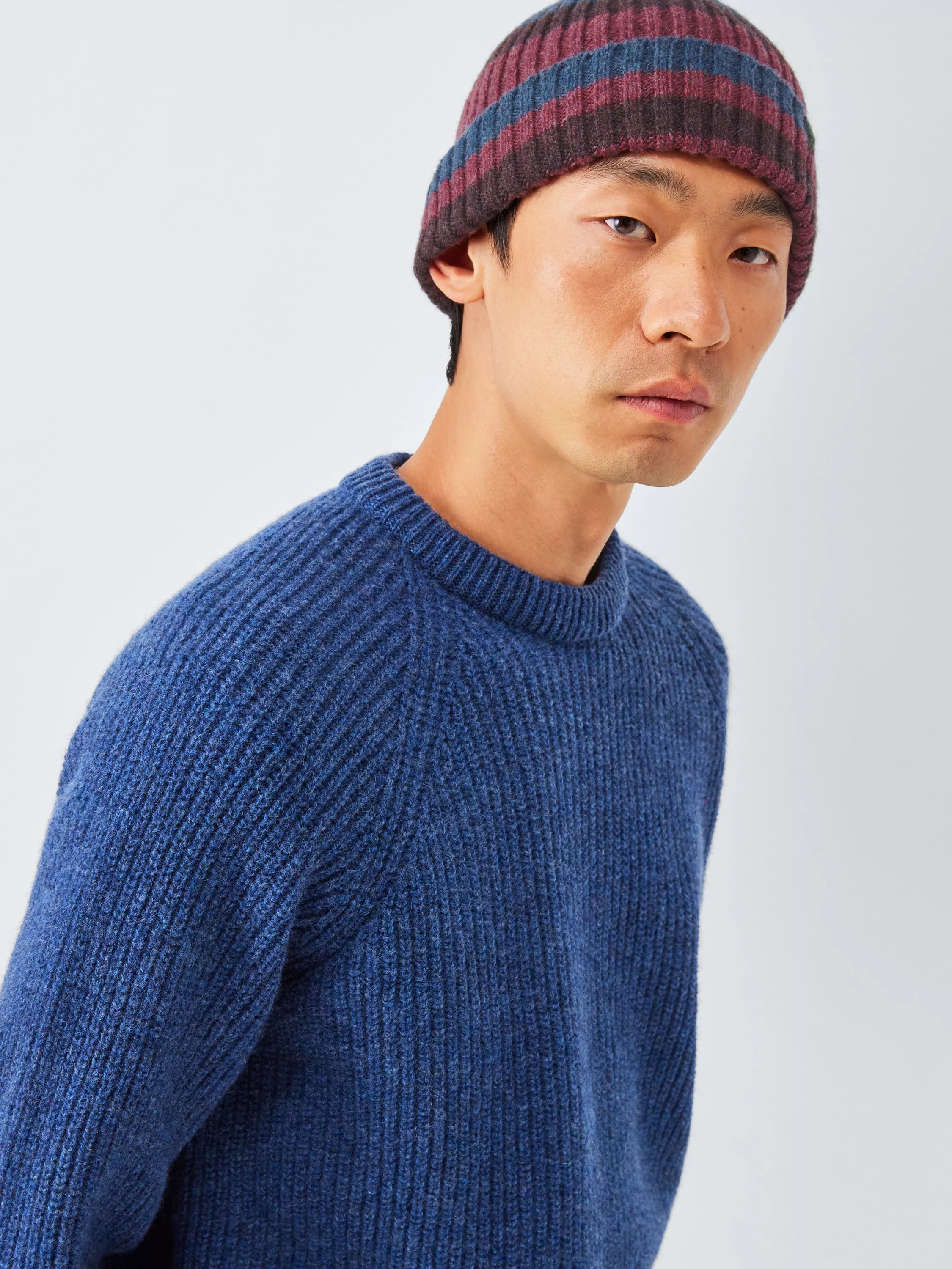 Man wearing a multi colour wool beanie hat