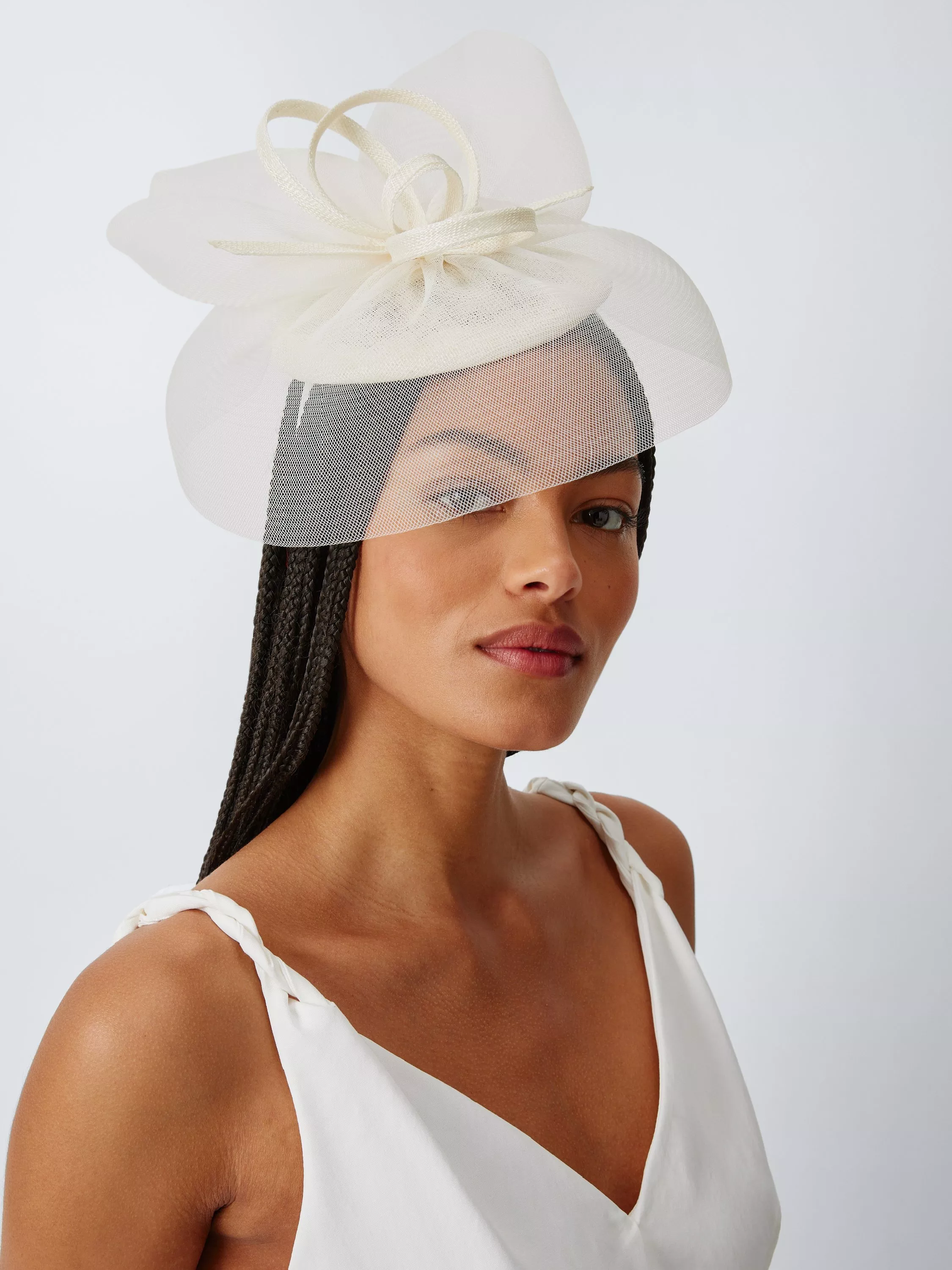 woman wearing an ivory beret fascinator