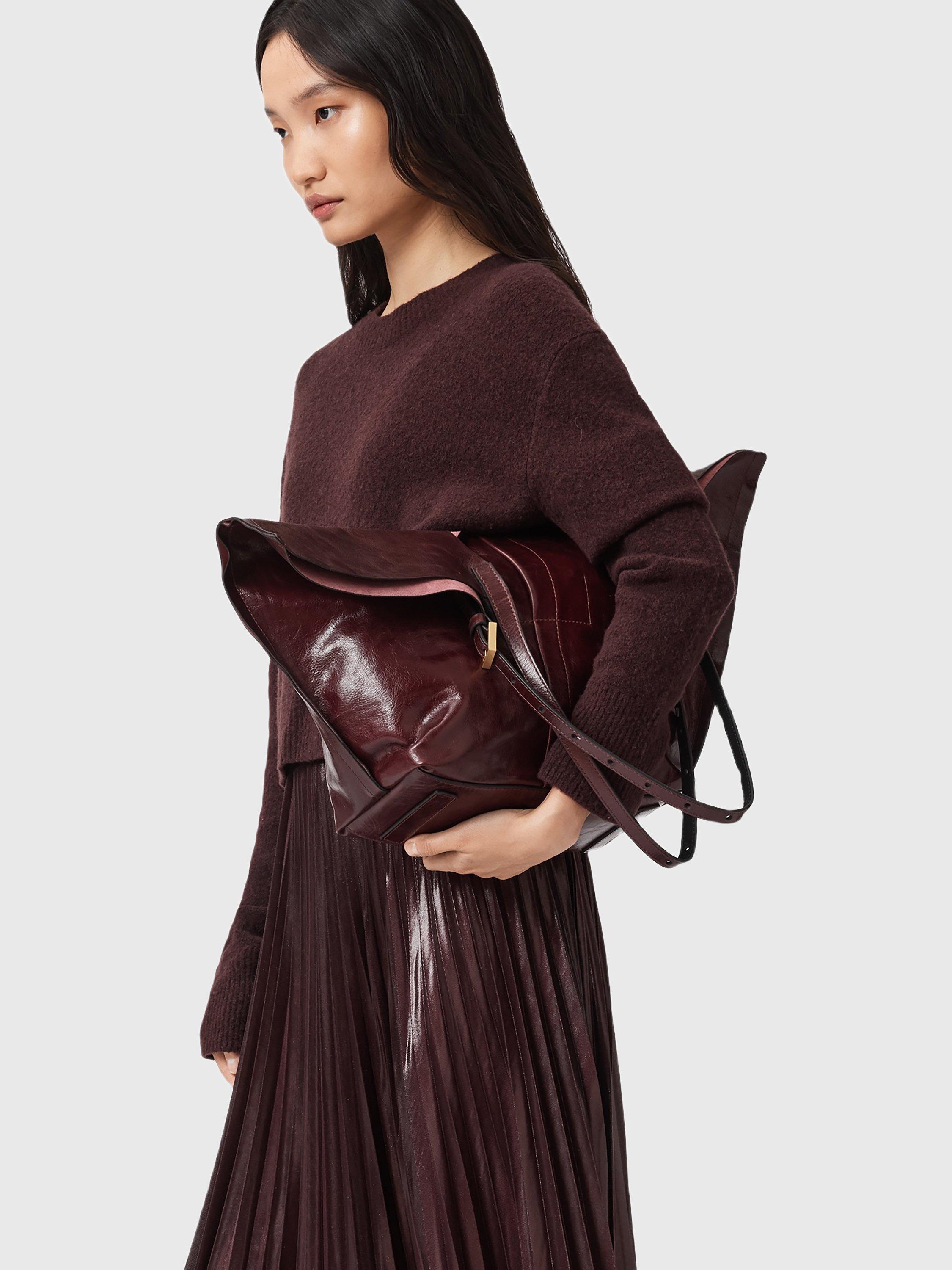 Product image 4 of 7, which shows AllSaints Ara Leather Tote Bag, Dark Red