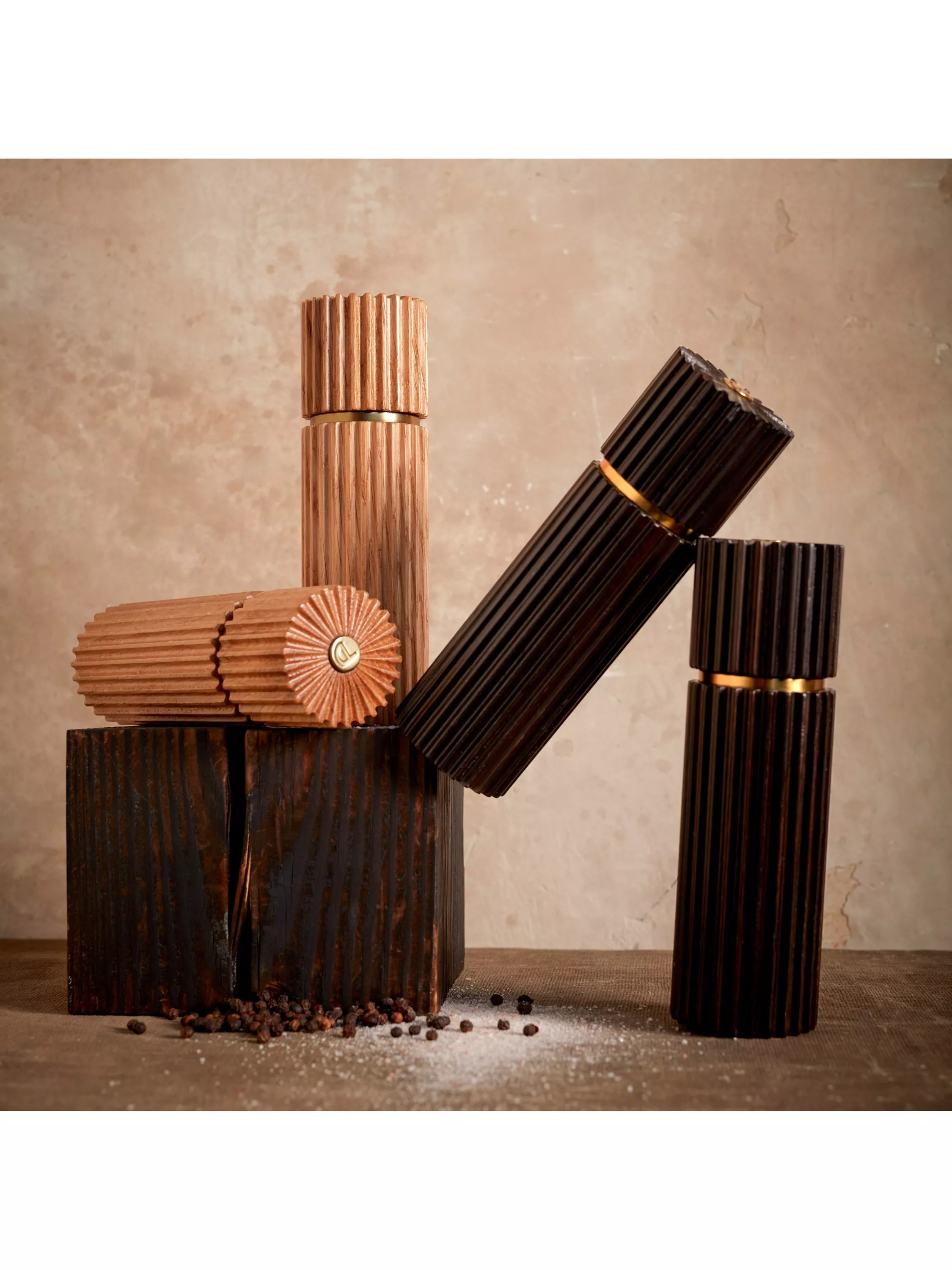Modern bookshelf styling with vintage books and white ceramic artichoke ornaments on wooden bases