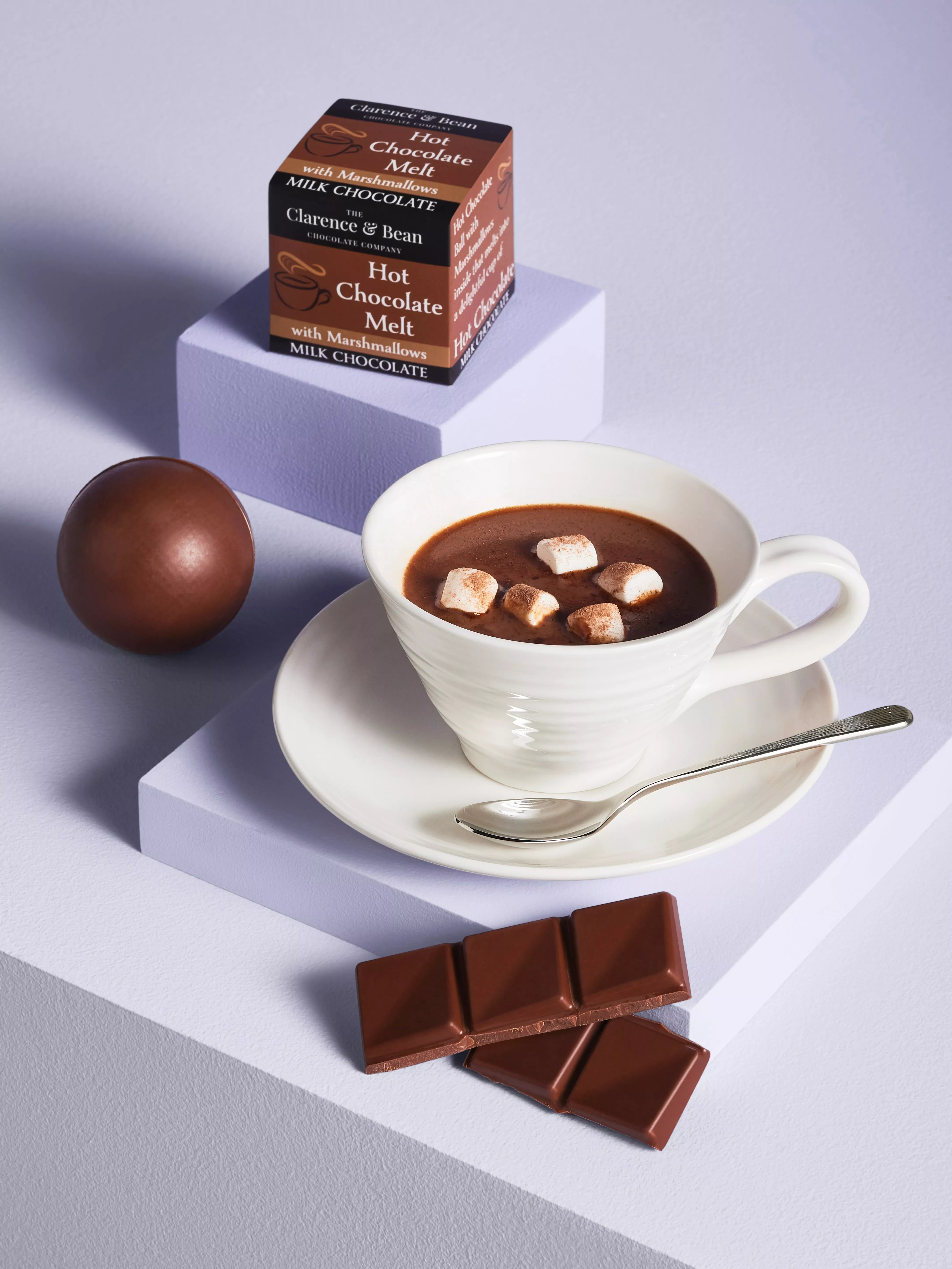 Cup of hot chocolate with marshmallows, milk chocolate pieces and Clarence & Bean hot chocolate melt box