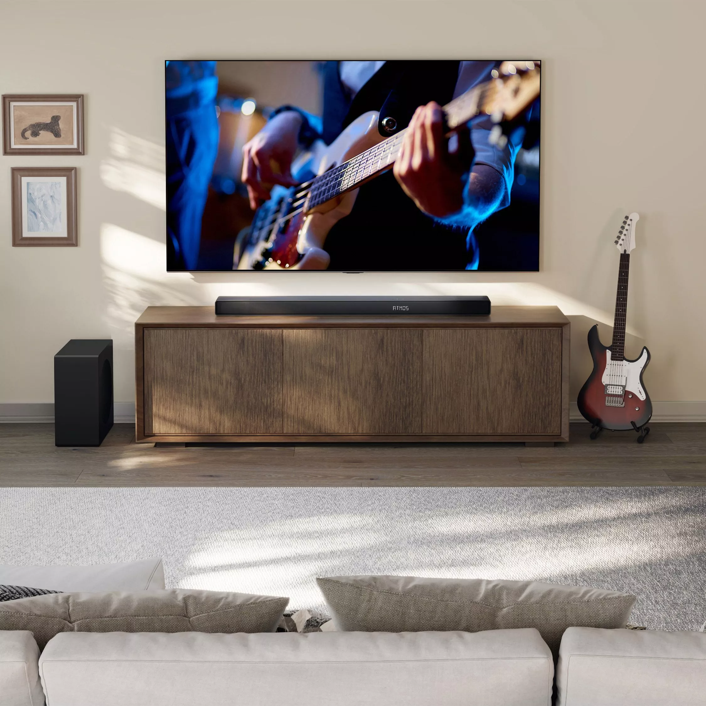 Sleek black soundbar on wooden media console beneath wall-mounted TV in modern living room interior.