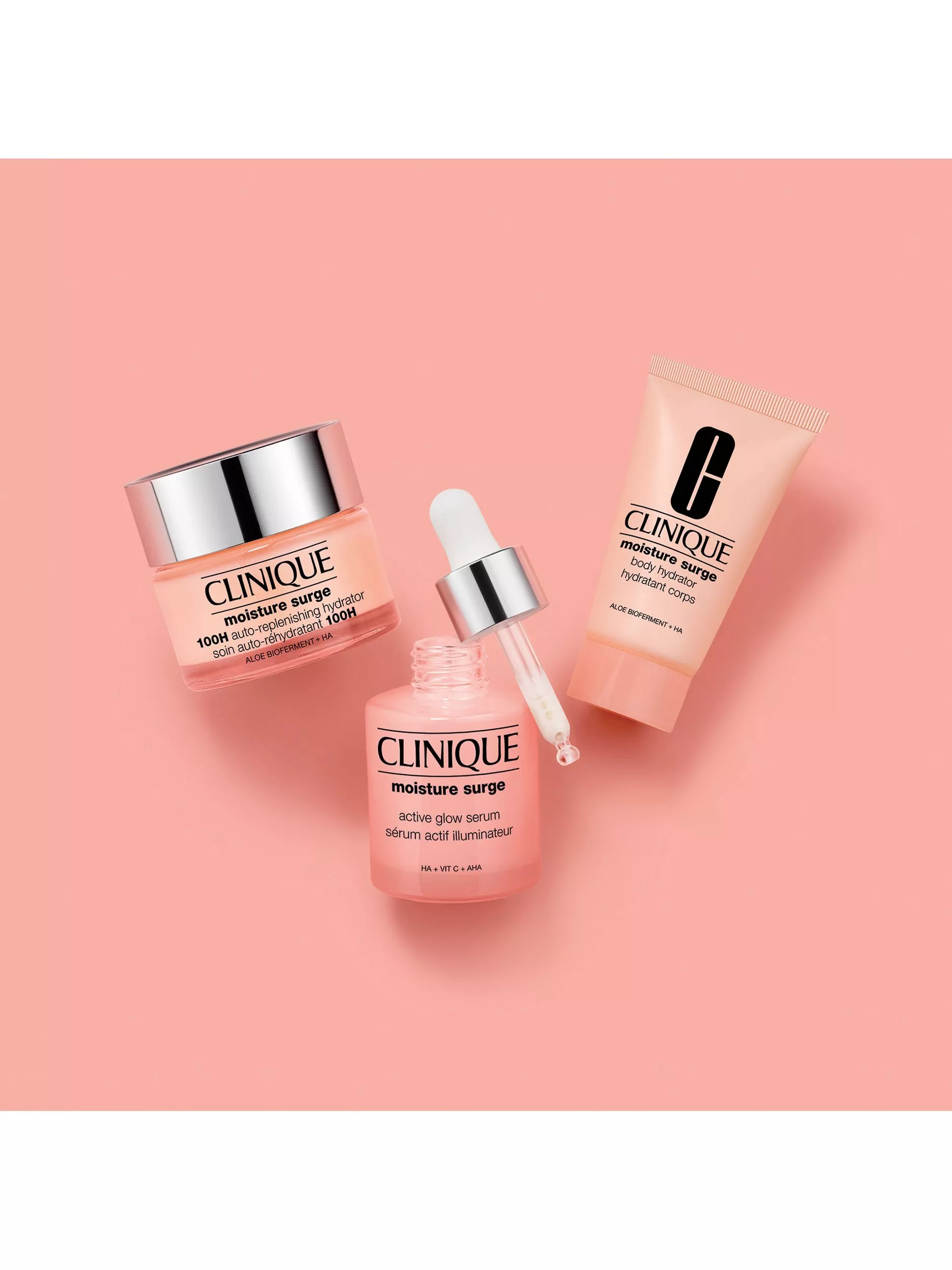 Clinique Moisture Surge products on a pink background, featuring a cream, serum, and body hydrator.