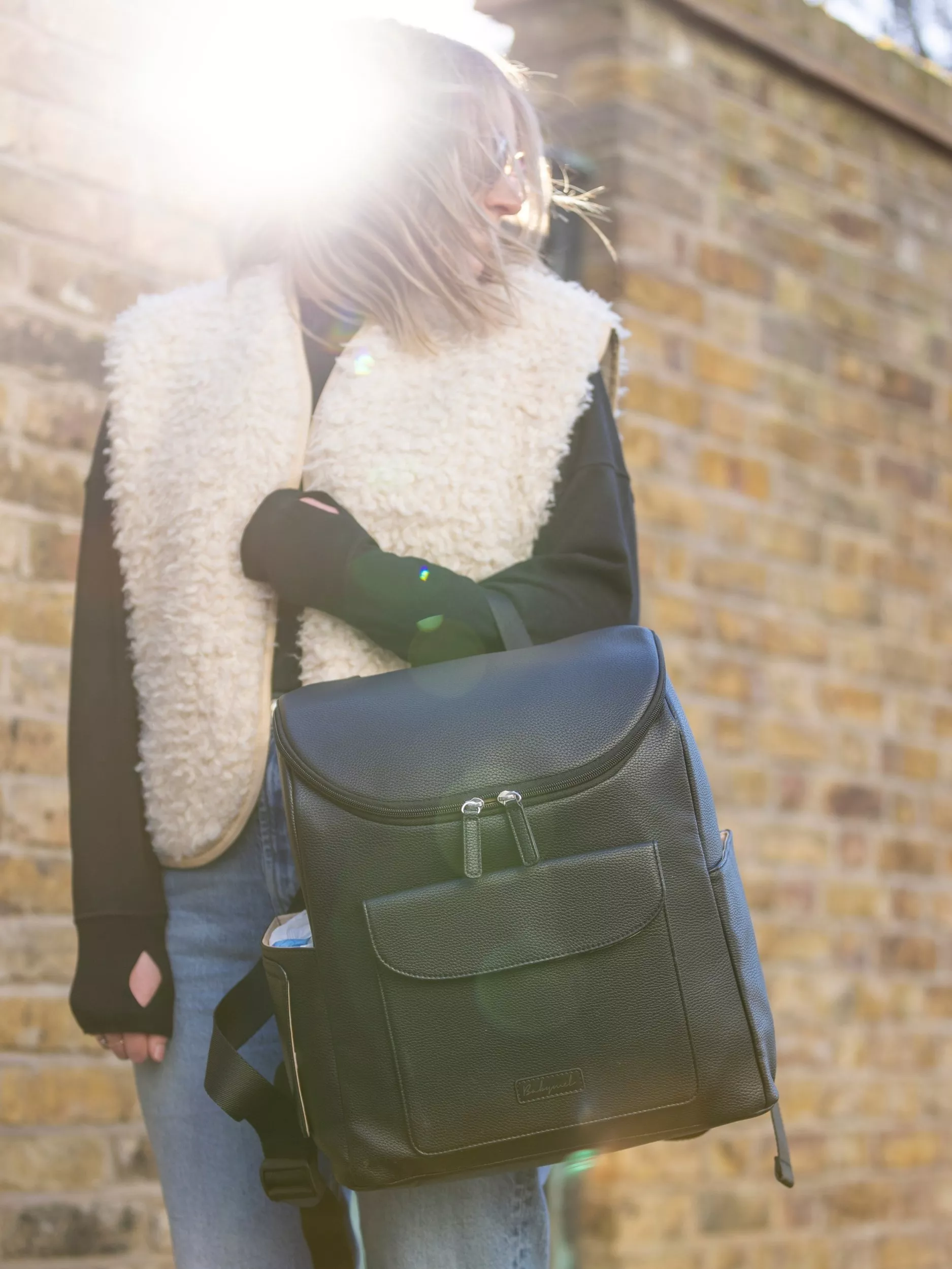 Women carrying a black changing backpack