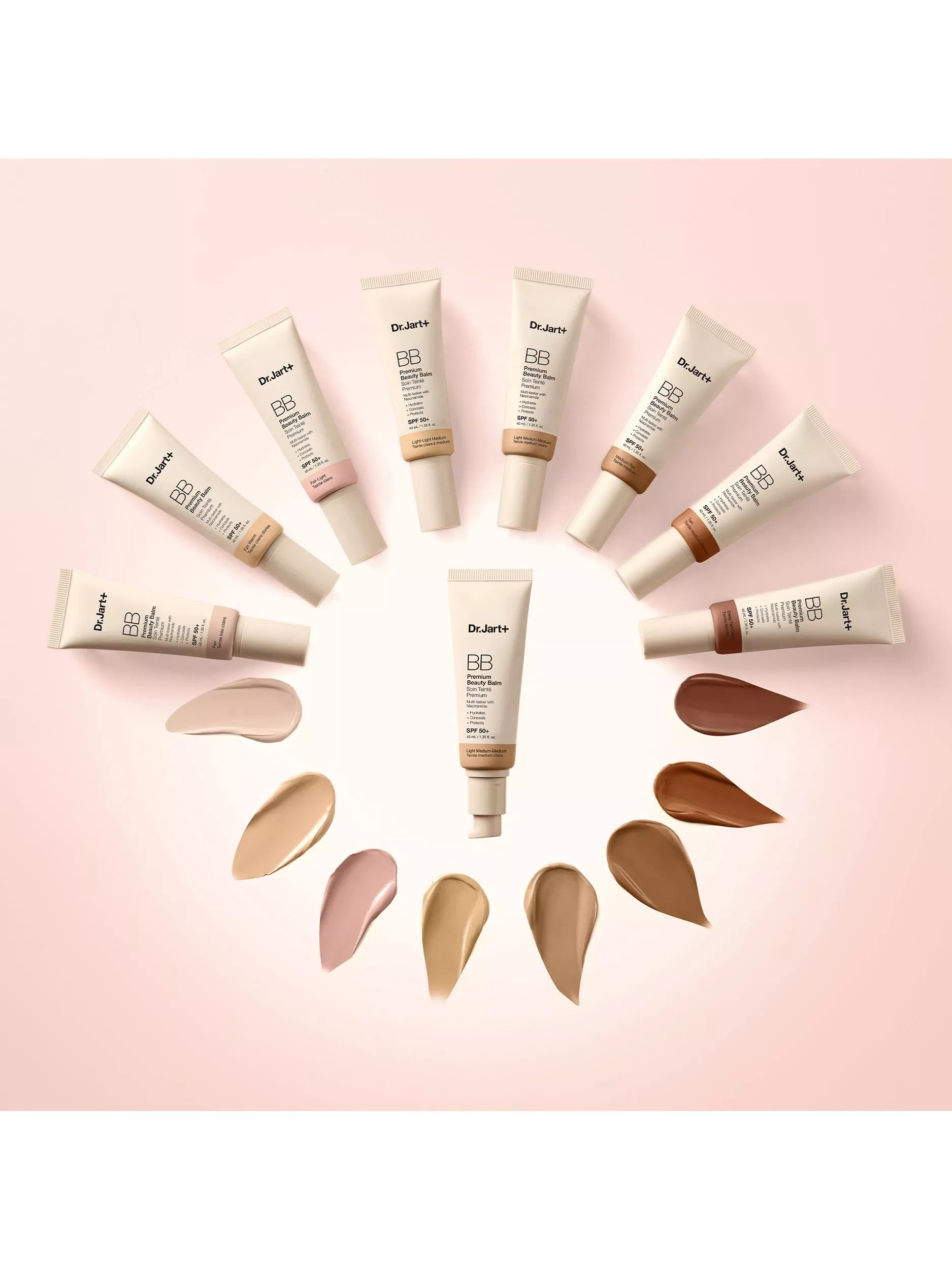 Dr.Jart+ BB cream tubes in a circle with foundation swatches, showcasing multiple shades on pink backdrop