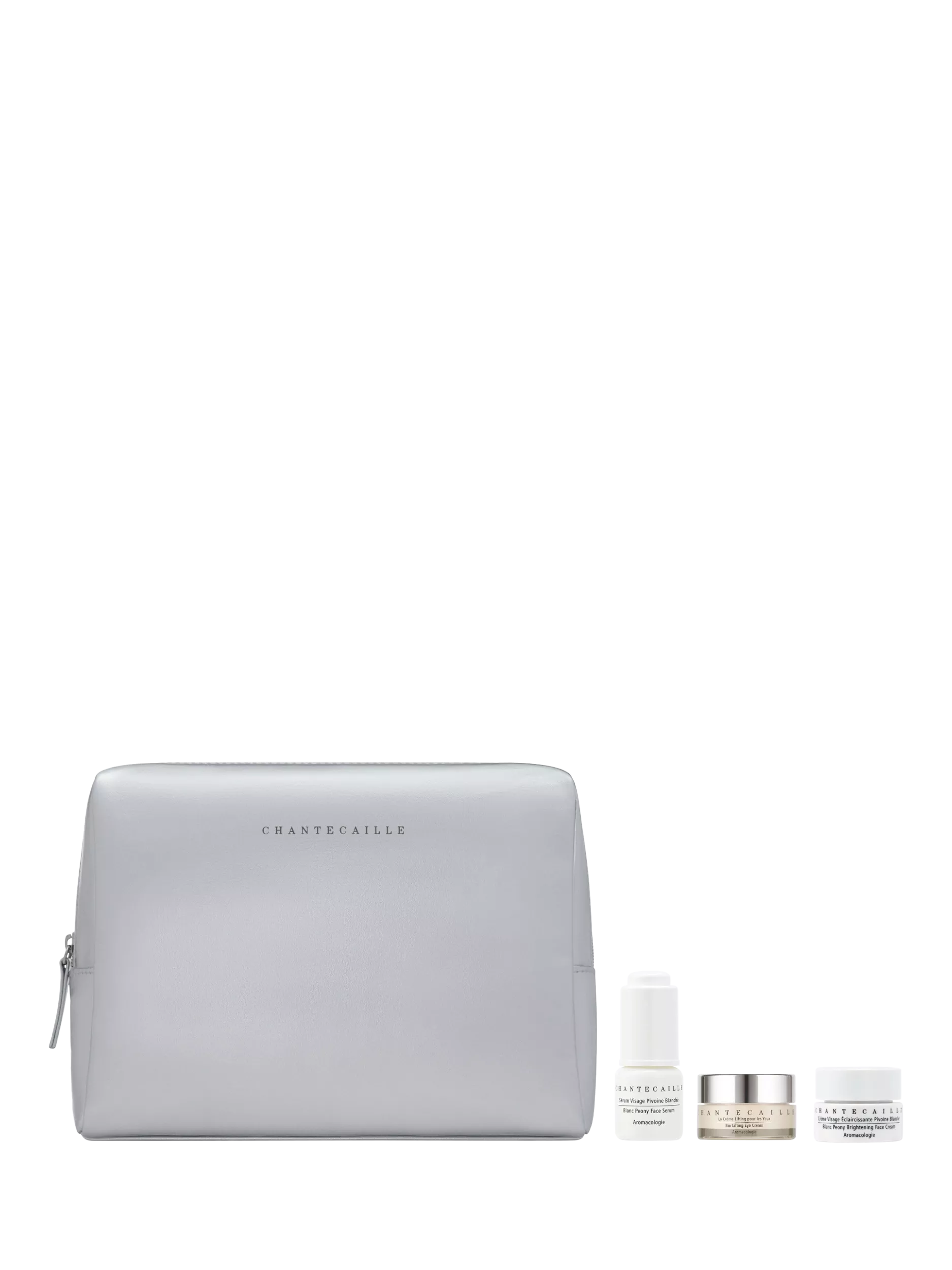 Chantecaille travel skincare set with grey cosmetic bag, face serum, eye cream and brightening face cream trio