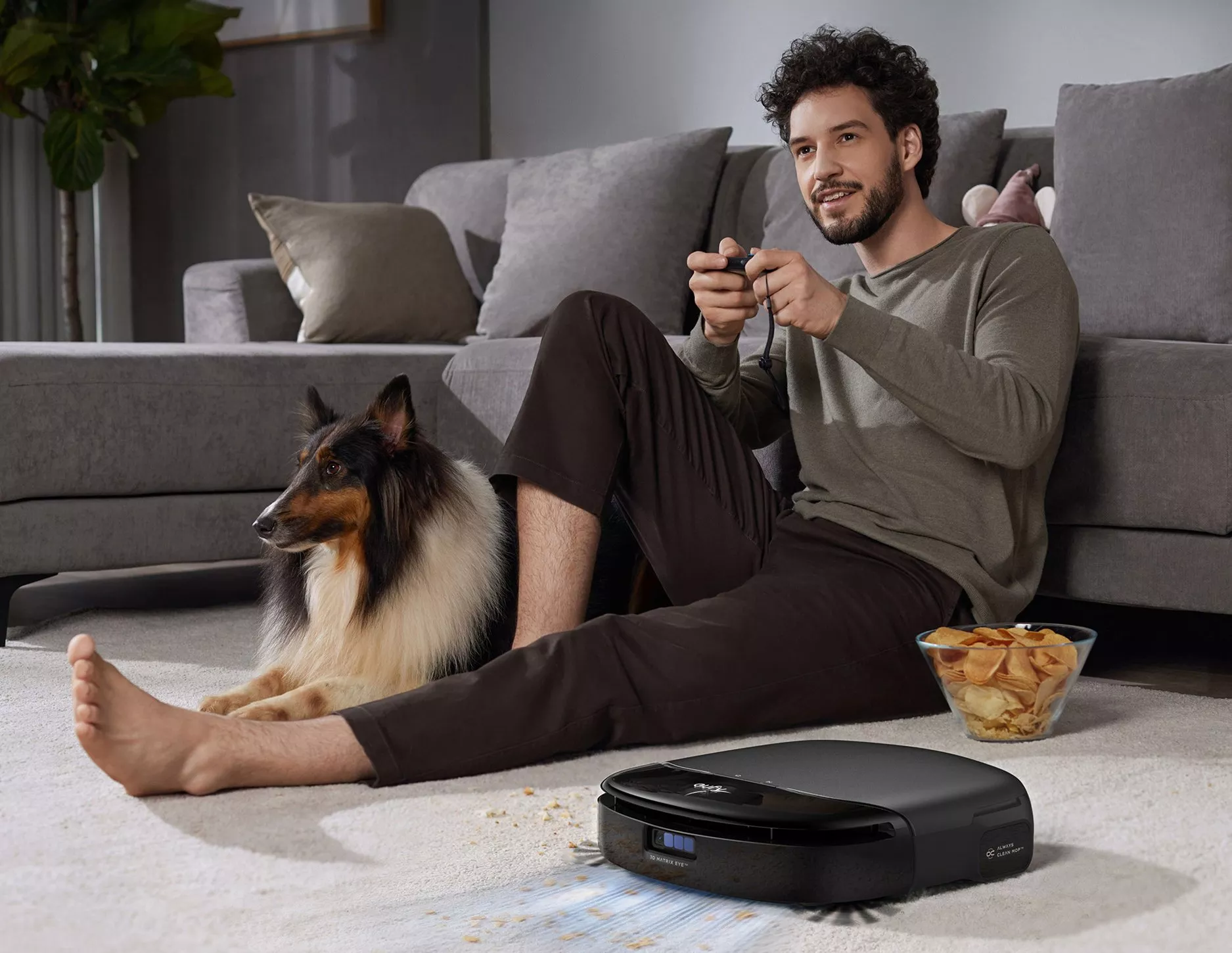Dyson robot vacuum cleaner mopping tiled floor, picking up wet spills and crumbs with LED light trail visible