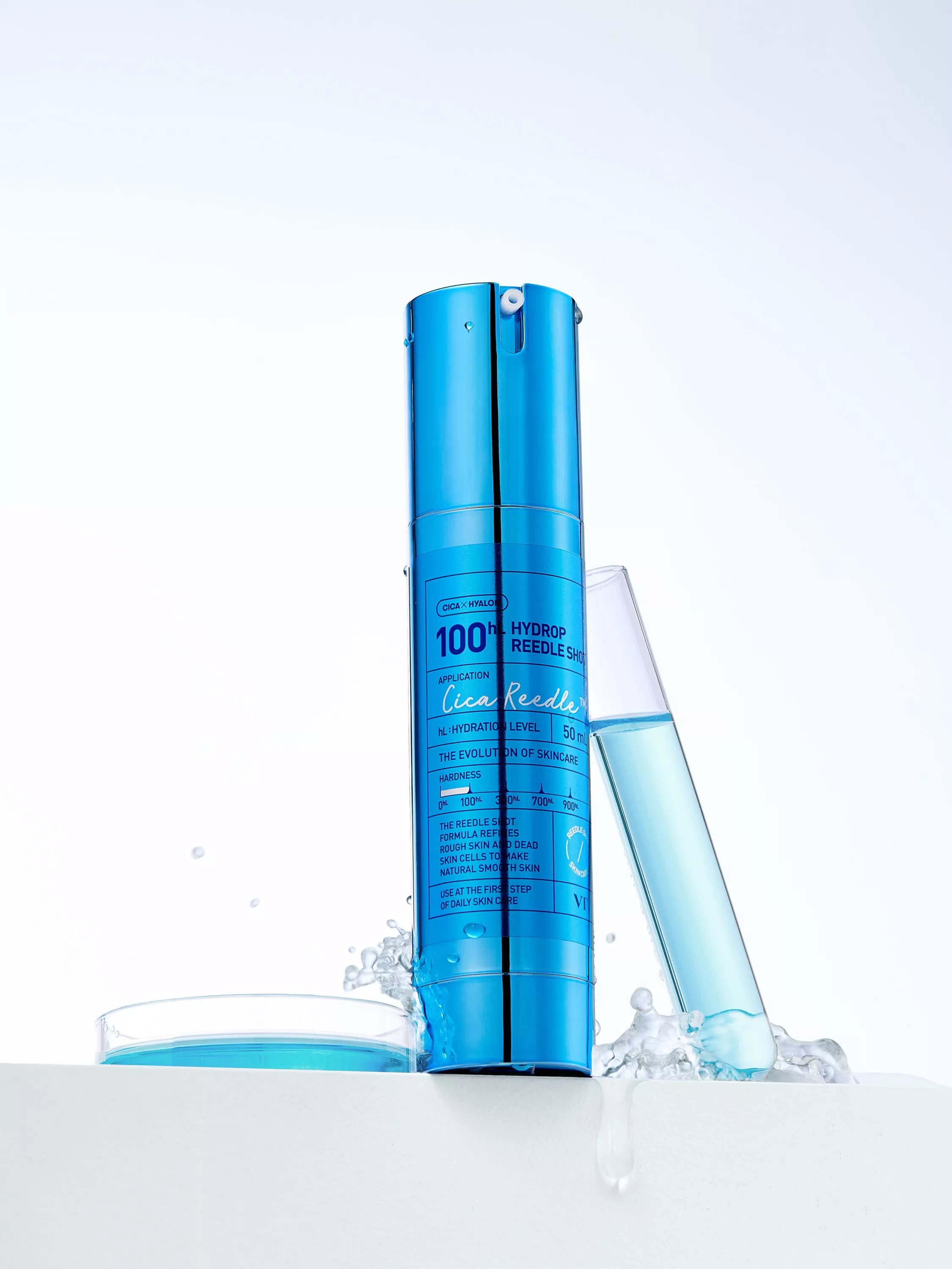 Blue hydrating skincare serum bottle with water splash and laboratory test tube on clean white background