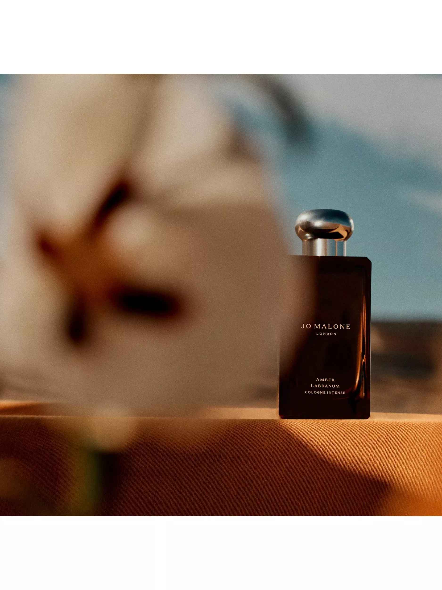 Narciso Rodriguez For Him Musc Santal eau de parfum bottle with berries, sage leaves and sandalwood sticks