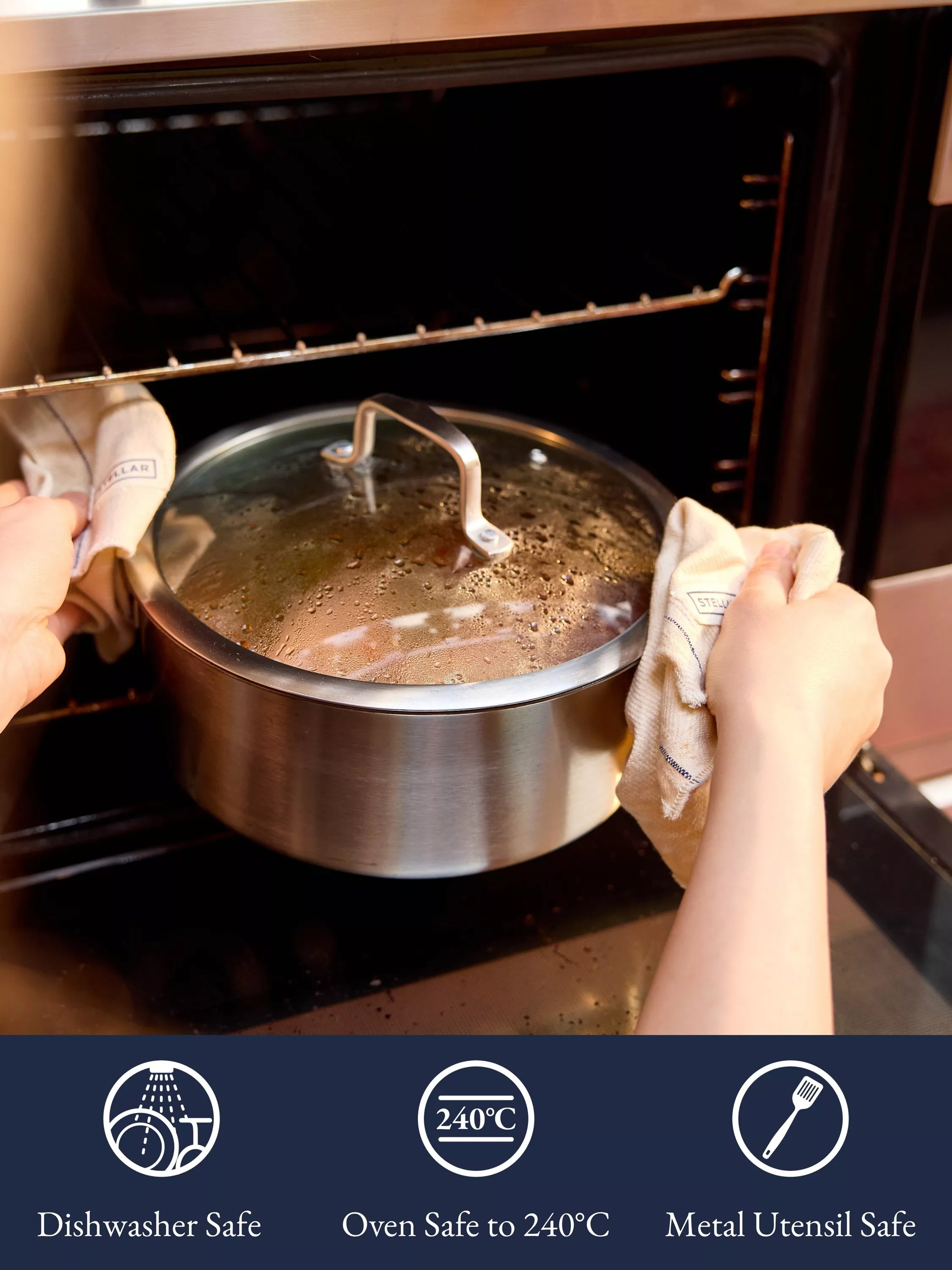 Stainless steel lidded saucepan on gas hob in home kitchen, with wooden utensils and herbs in background