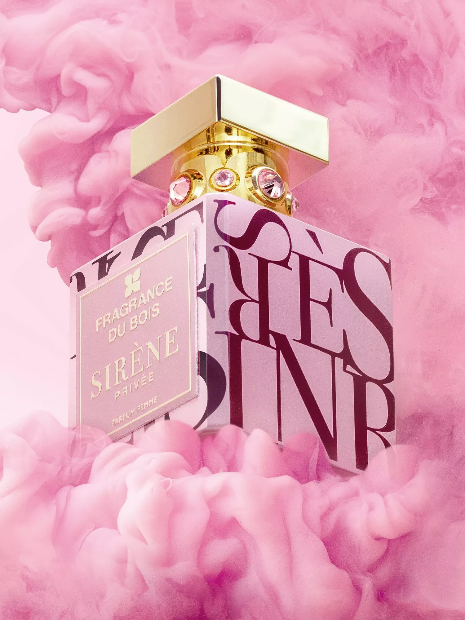 Fragrance Du Bois Sirène Privée perfume bottle with gold cap and jewels, surrounded by pink smoke backdrop