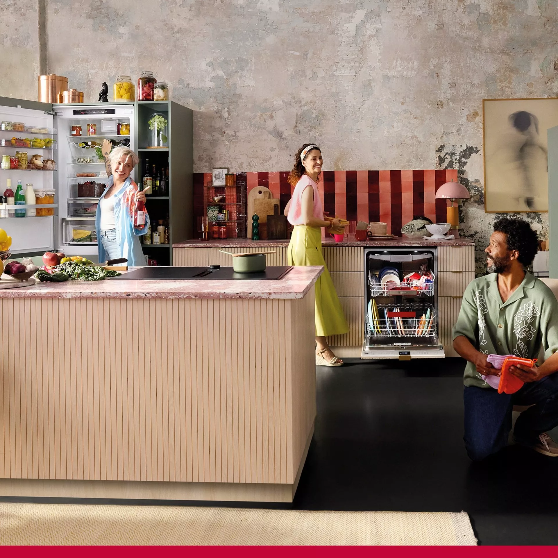 Three people using NEFF appliances in a modern kitchen. An open fridge and dishwasher are displayed alongside a cooktop while people interact in the space.