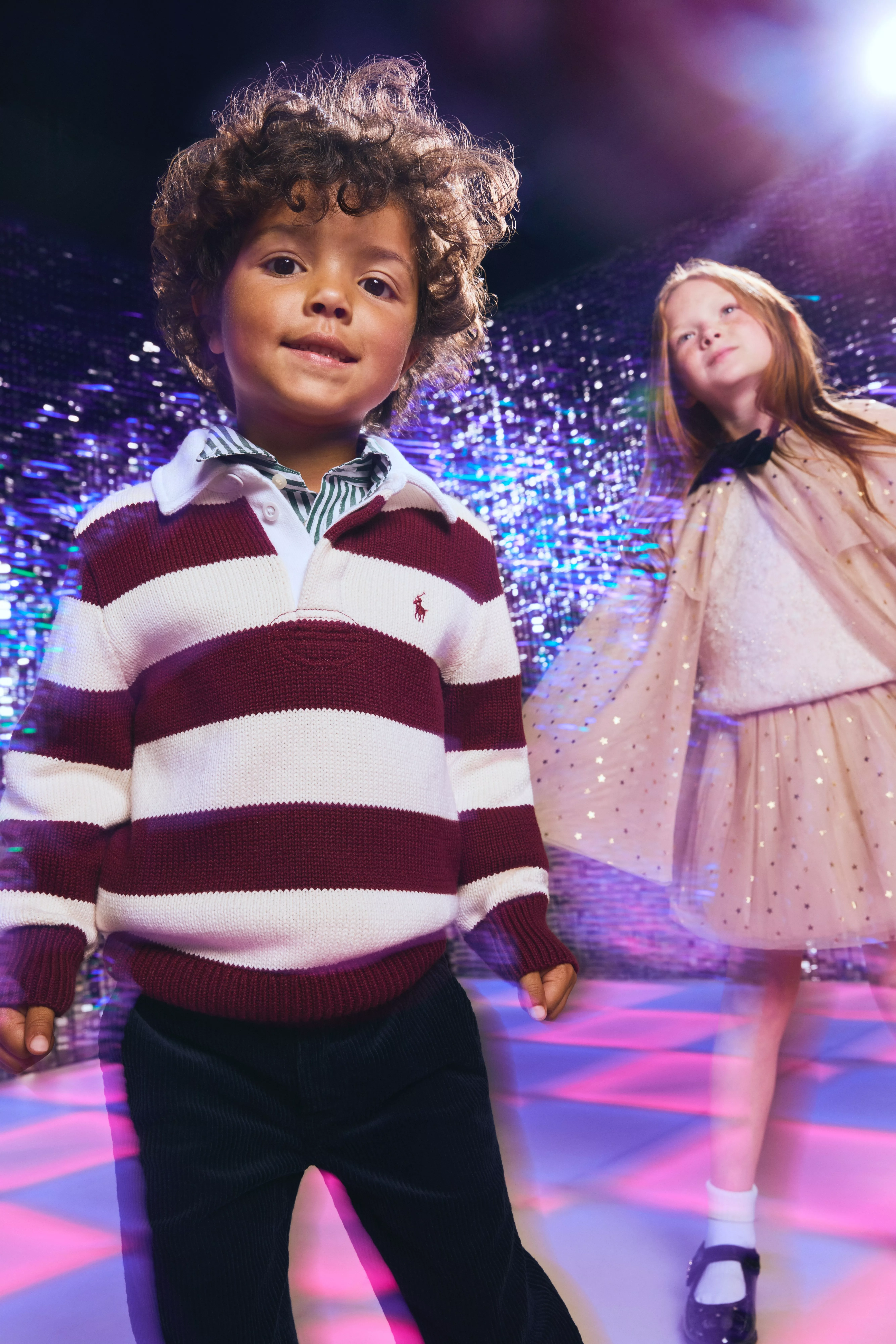 toddler boy wearing a red and white striped rugby shirt with shirt and trousers