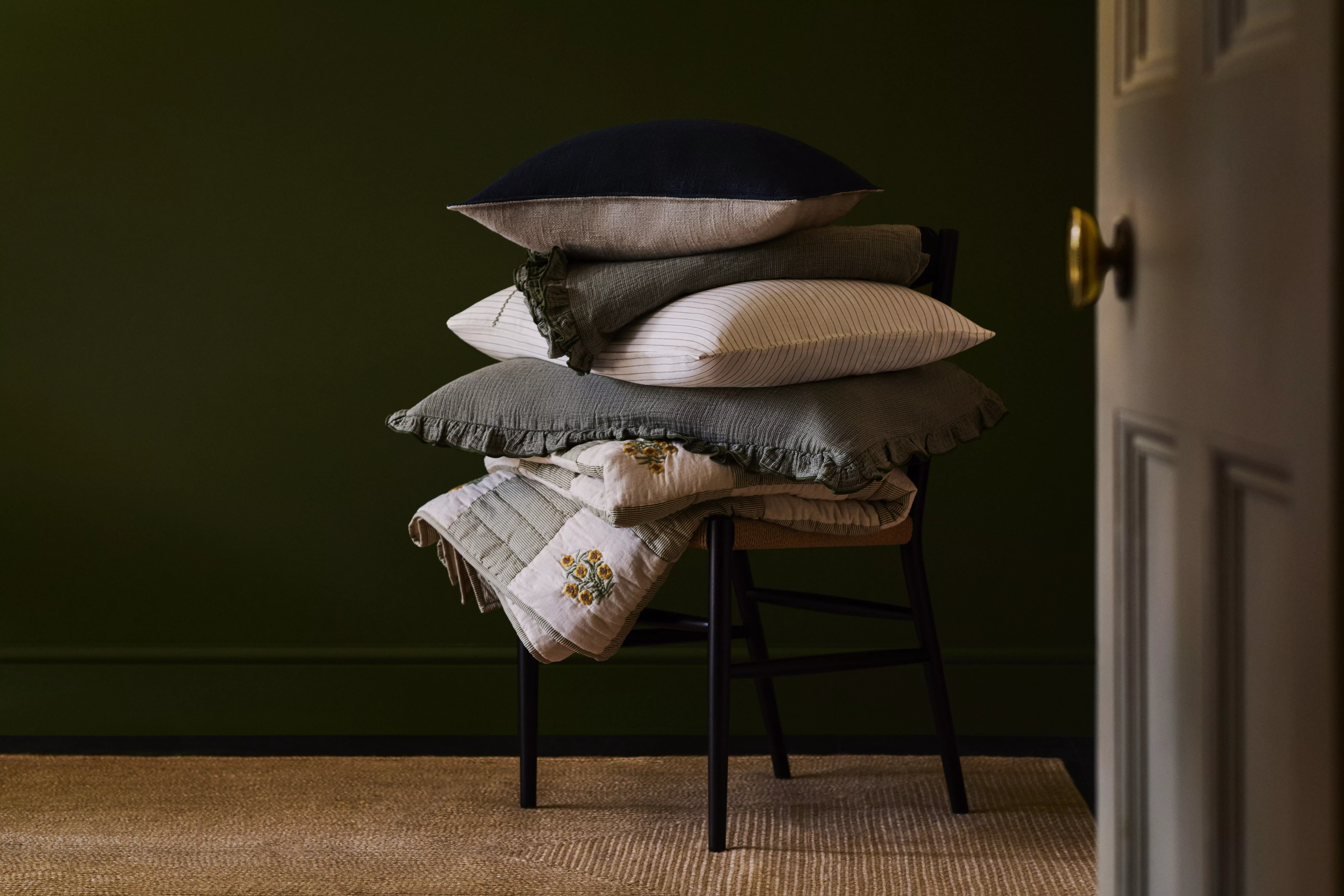 Floral cushions on a green sofa