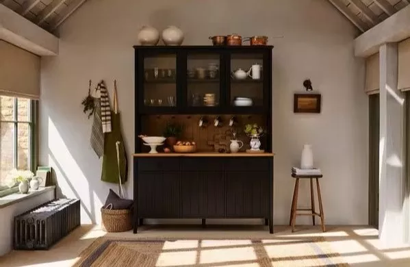 Living room with orange sofa, striped armchair and blue fireplace