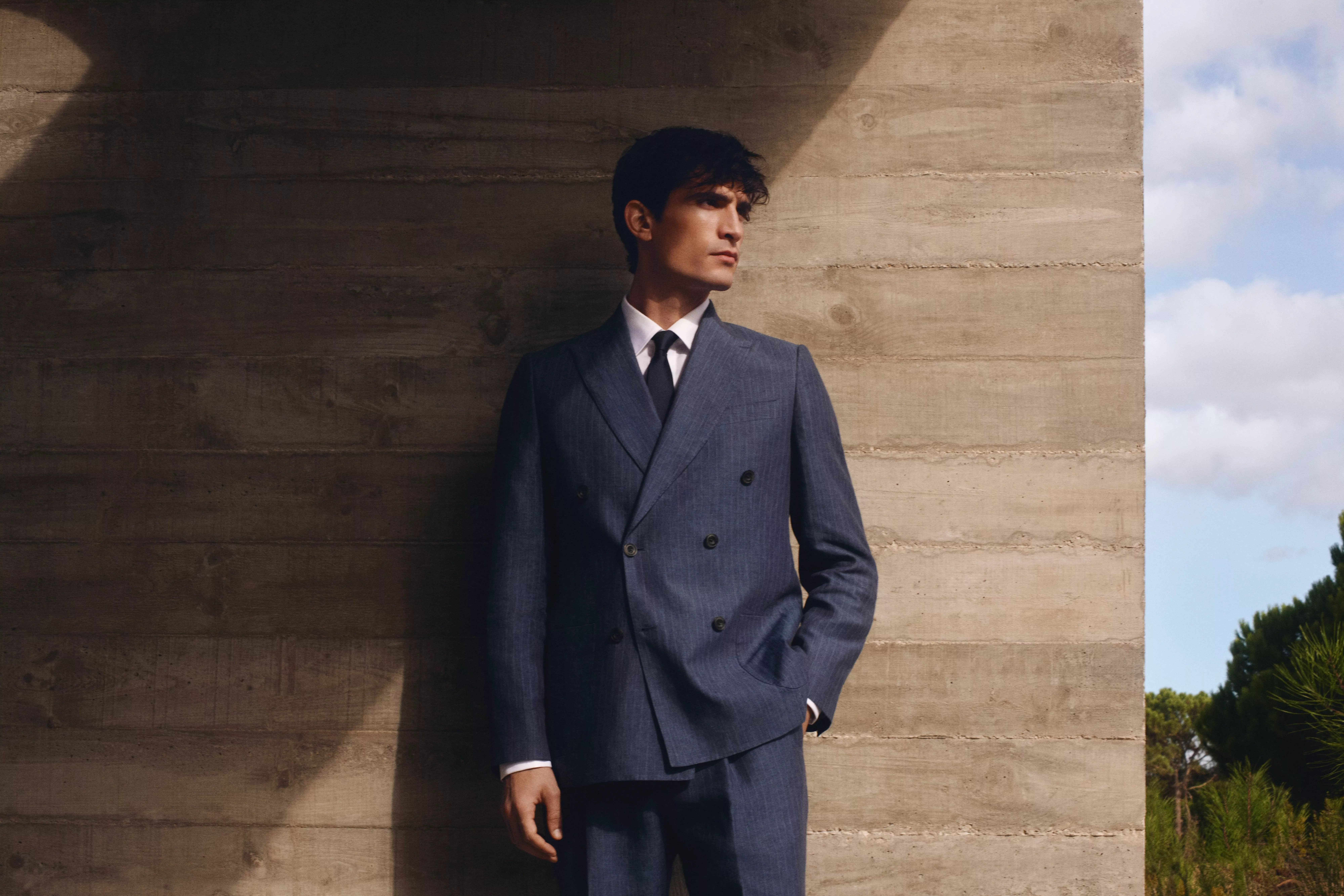 Man wearing tailored double breasted suit with white shirt and tie