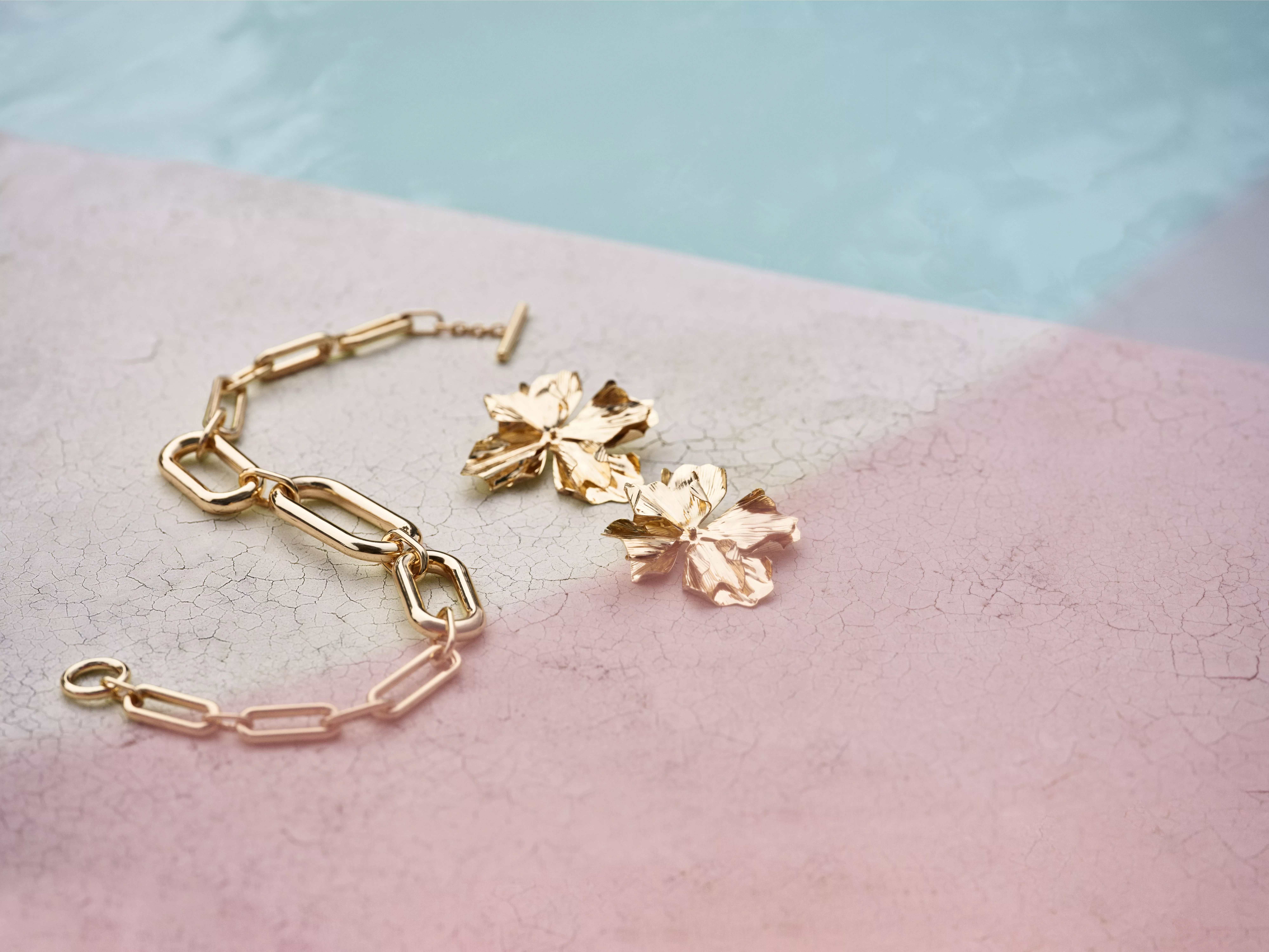 Gold chain and gold flower earrings