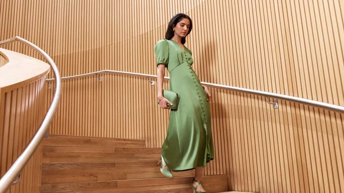 Two stylish individuals pose in denim outfits; one in a light denim jacket and the other in a dark denim shirt.