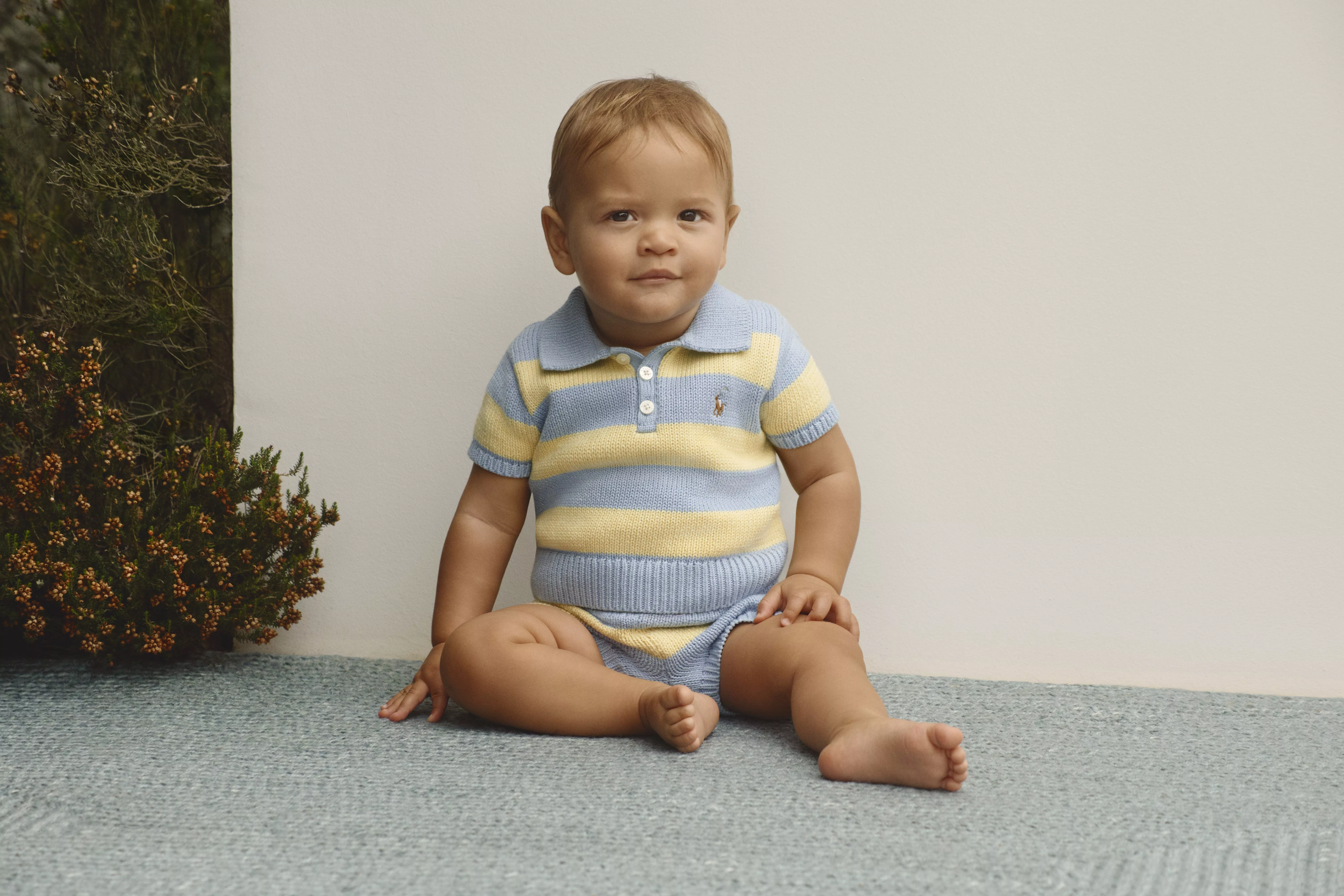 baby wearing blue and yellow stripe romper