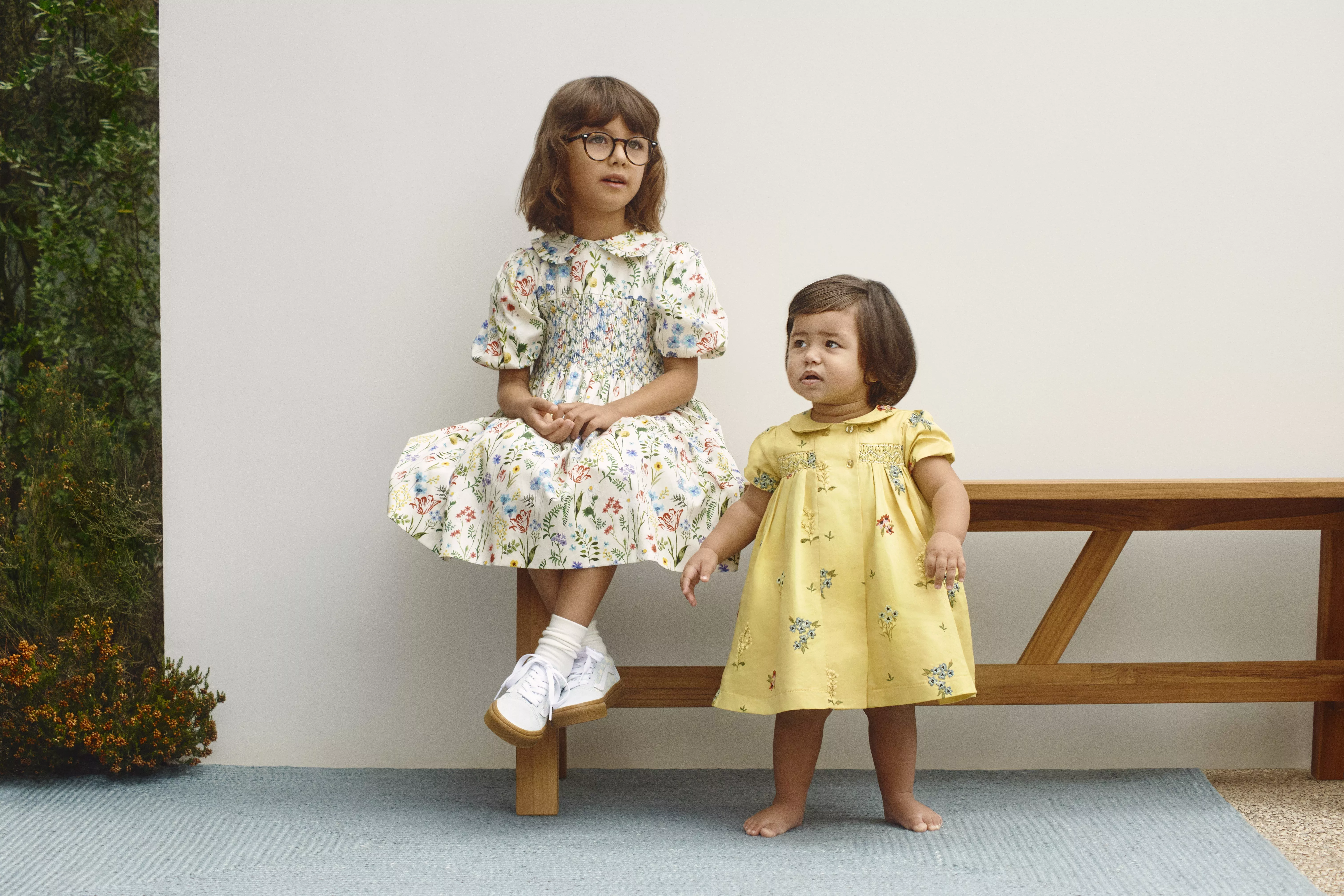 Two young girls wearing summer dresses