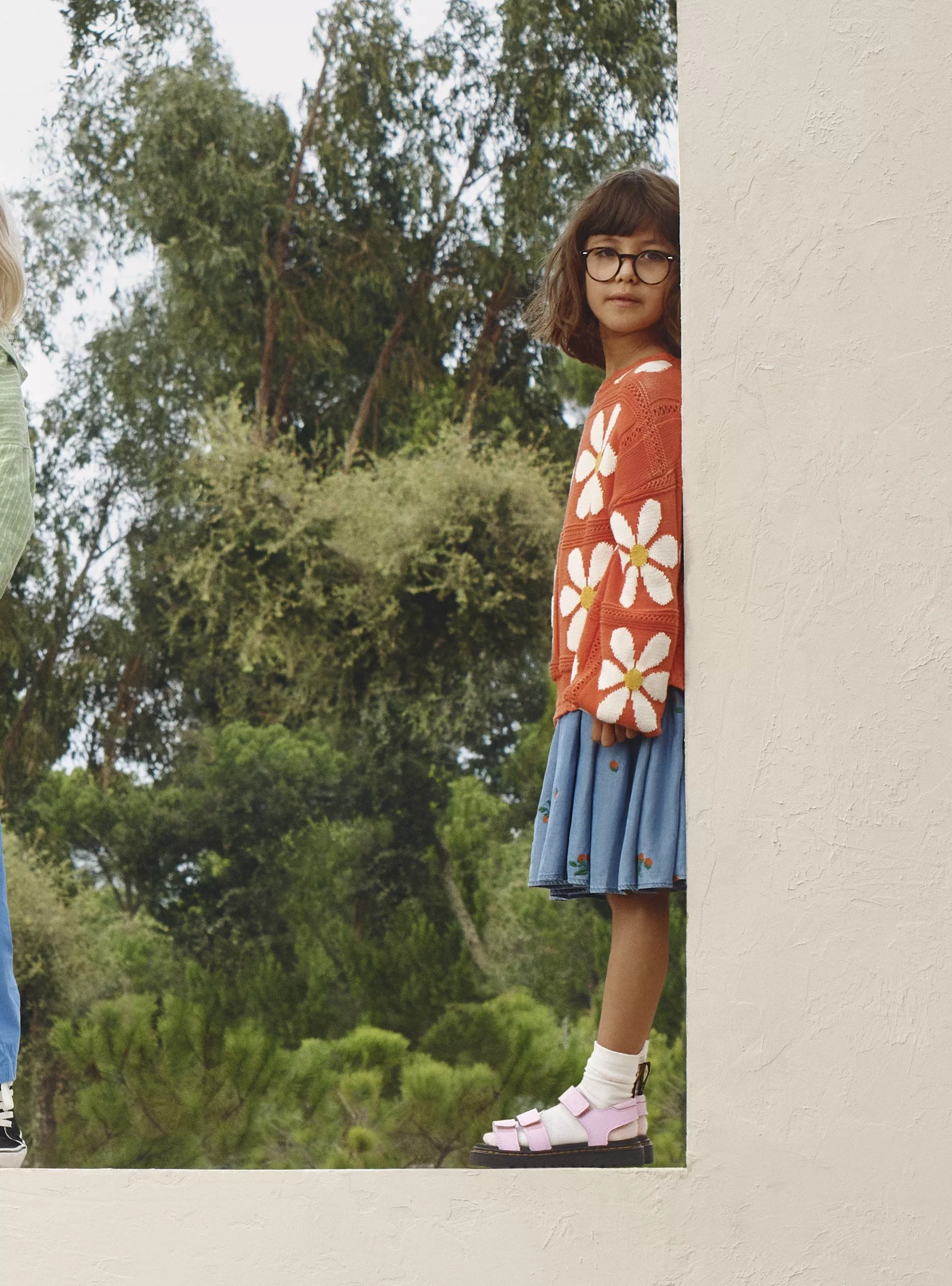 girl wearing orange jumper with white floral print