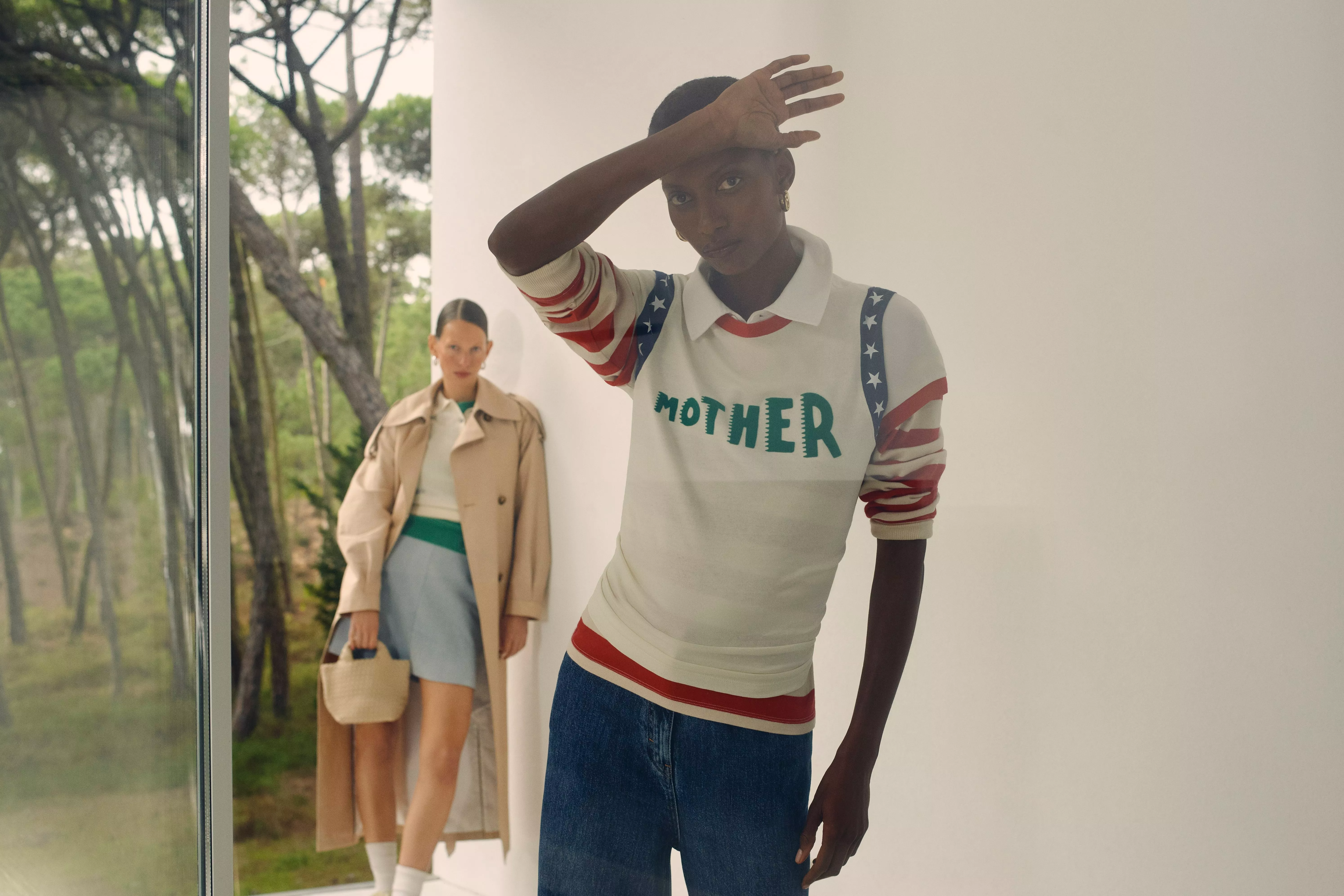 woman wearing a white jumper with slogan and pattern on it