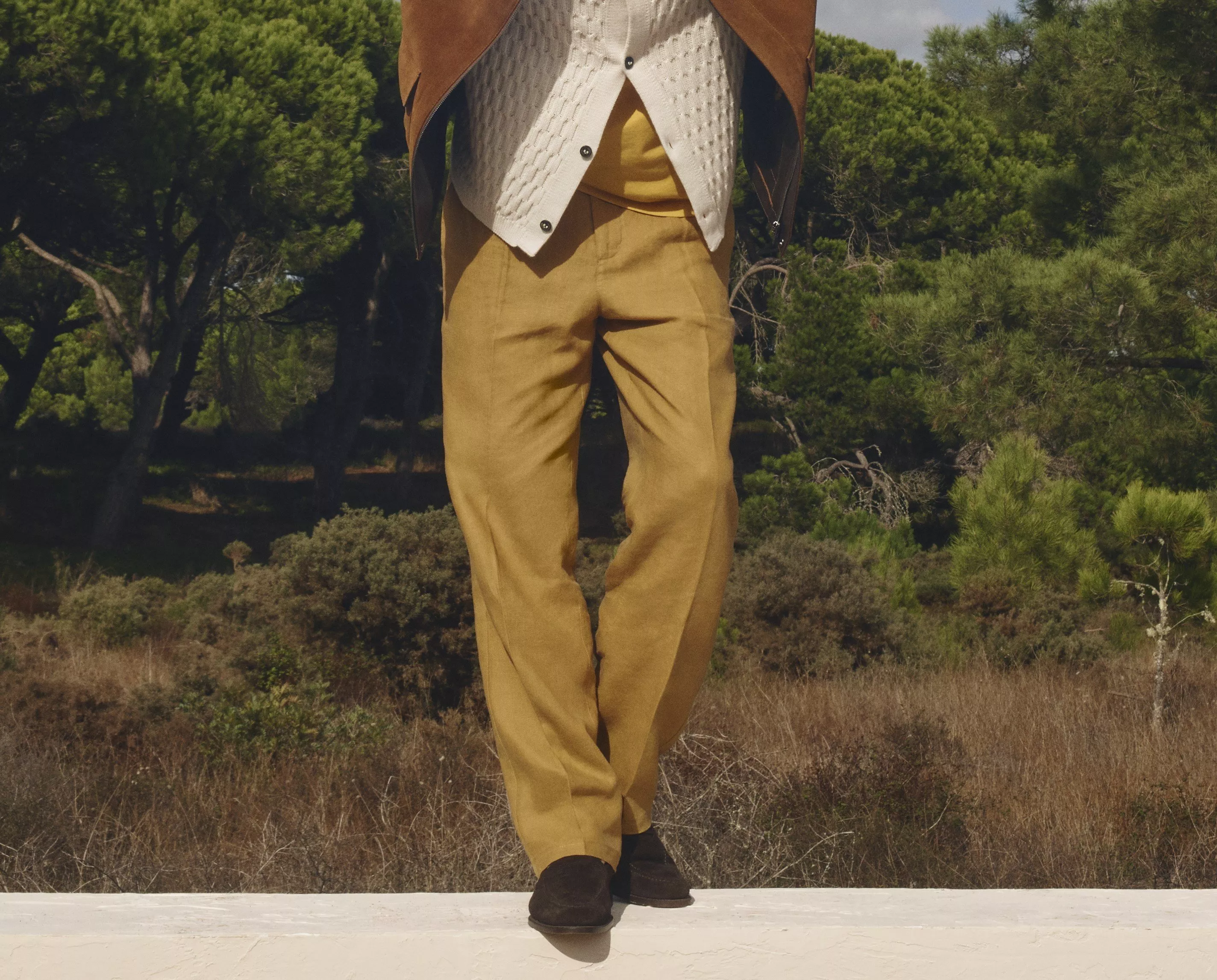 Man wearing mustard coloured trousers with brown suede loafers