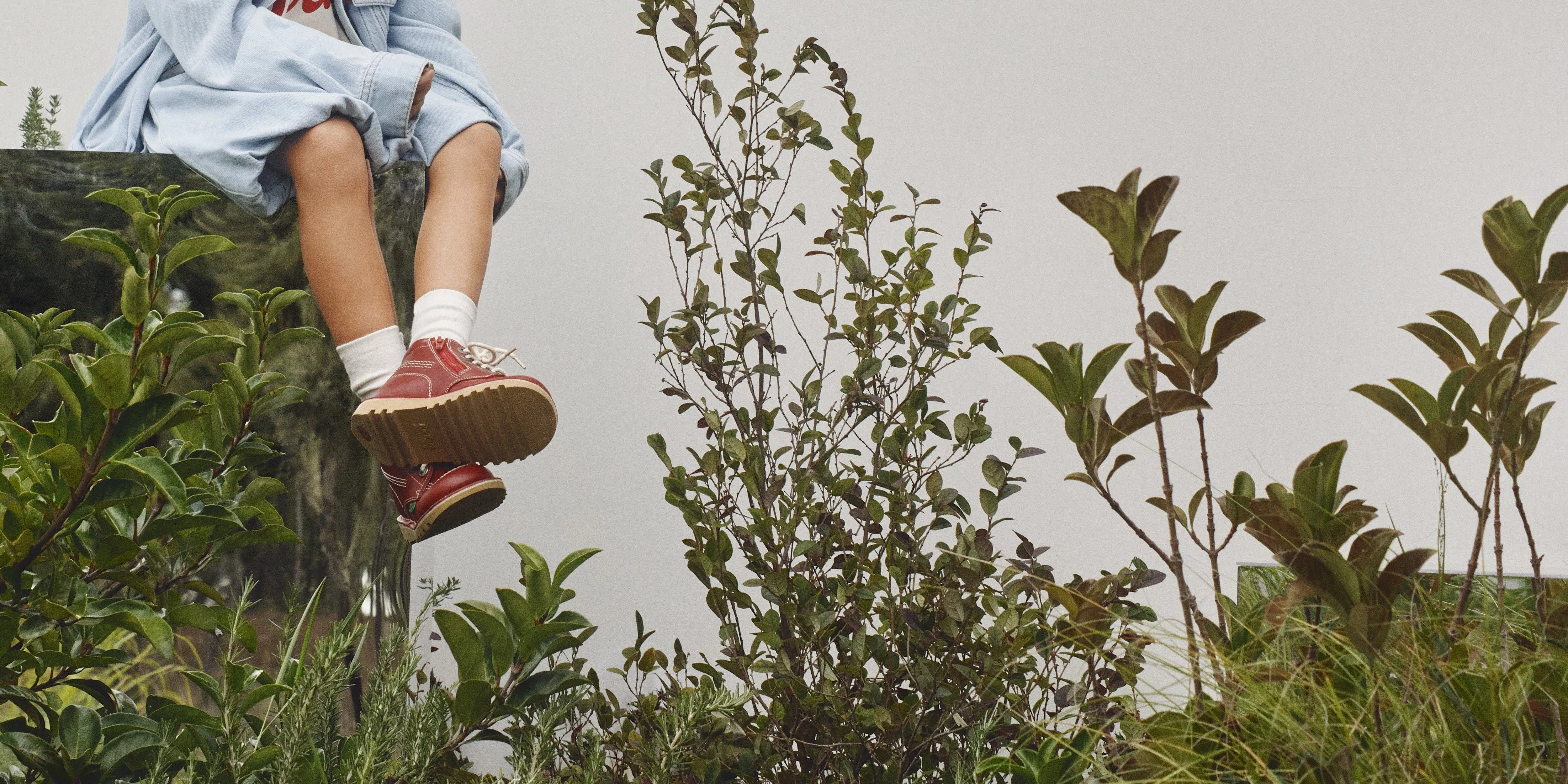 girl wearing matching denim jacket and skirt with red shoes and white socks