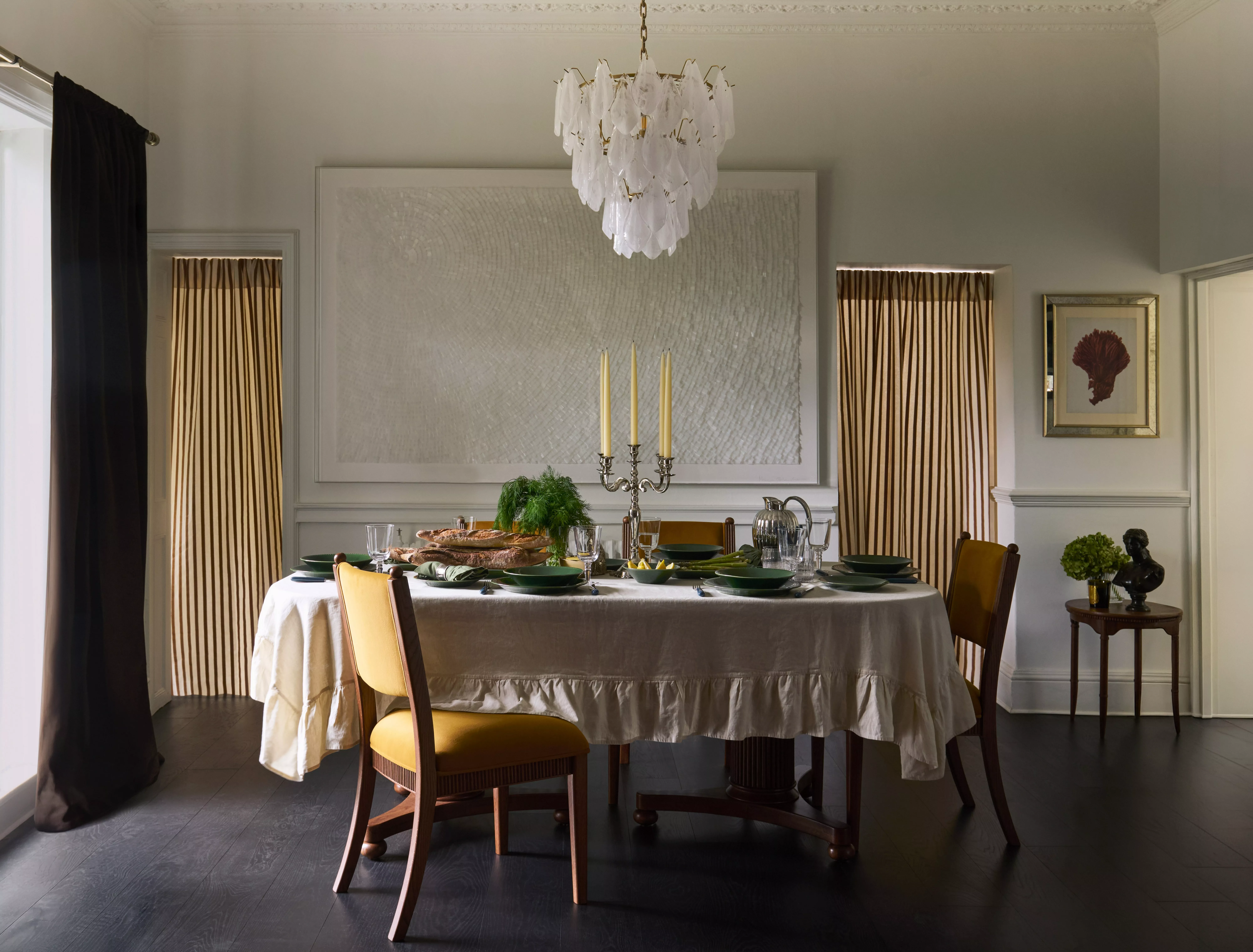 Modern dining room with wooden table, woven chairs, patterned rug and large window with garden view
