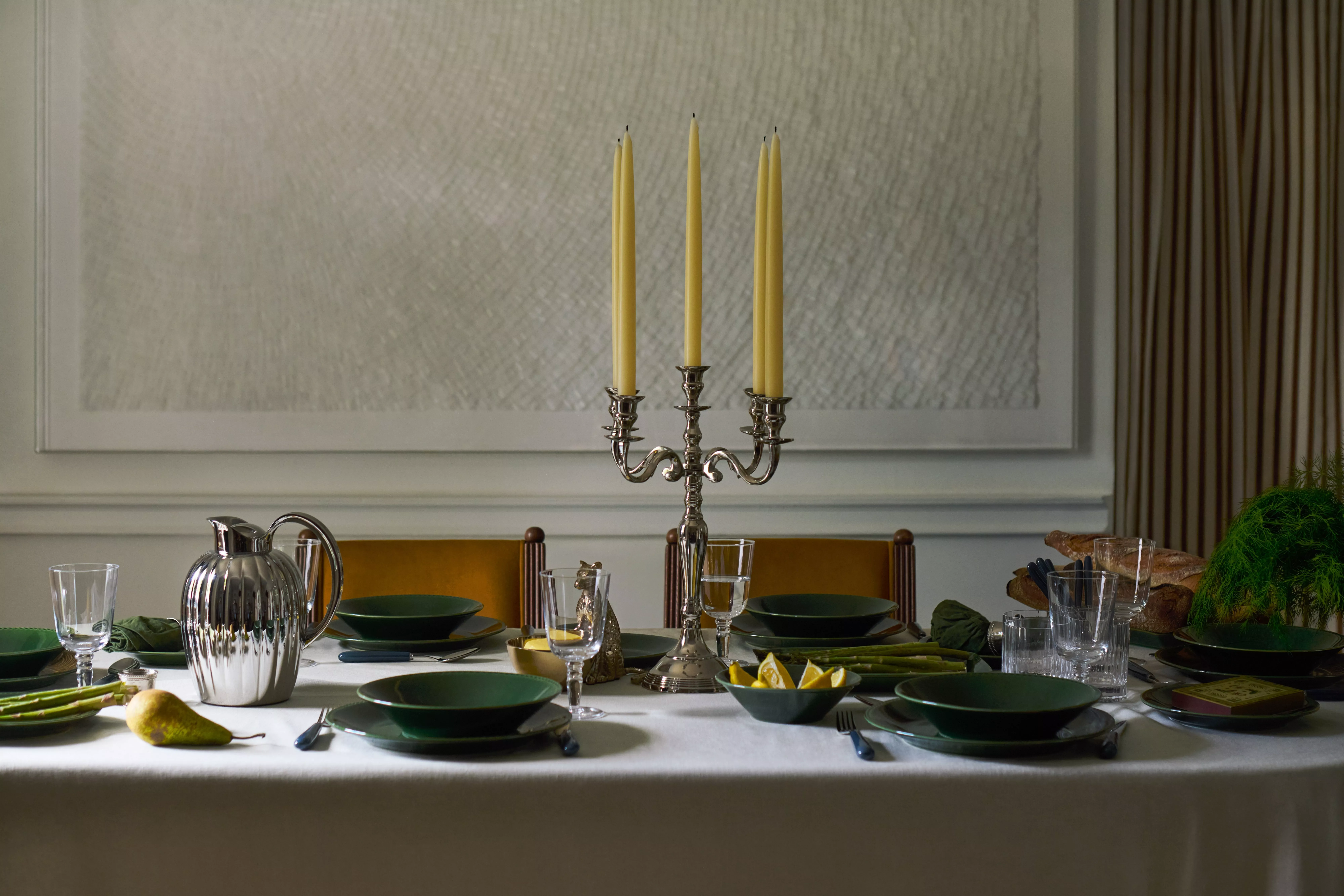 4 candles in candle holders of varying heights
