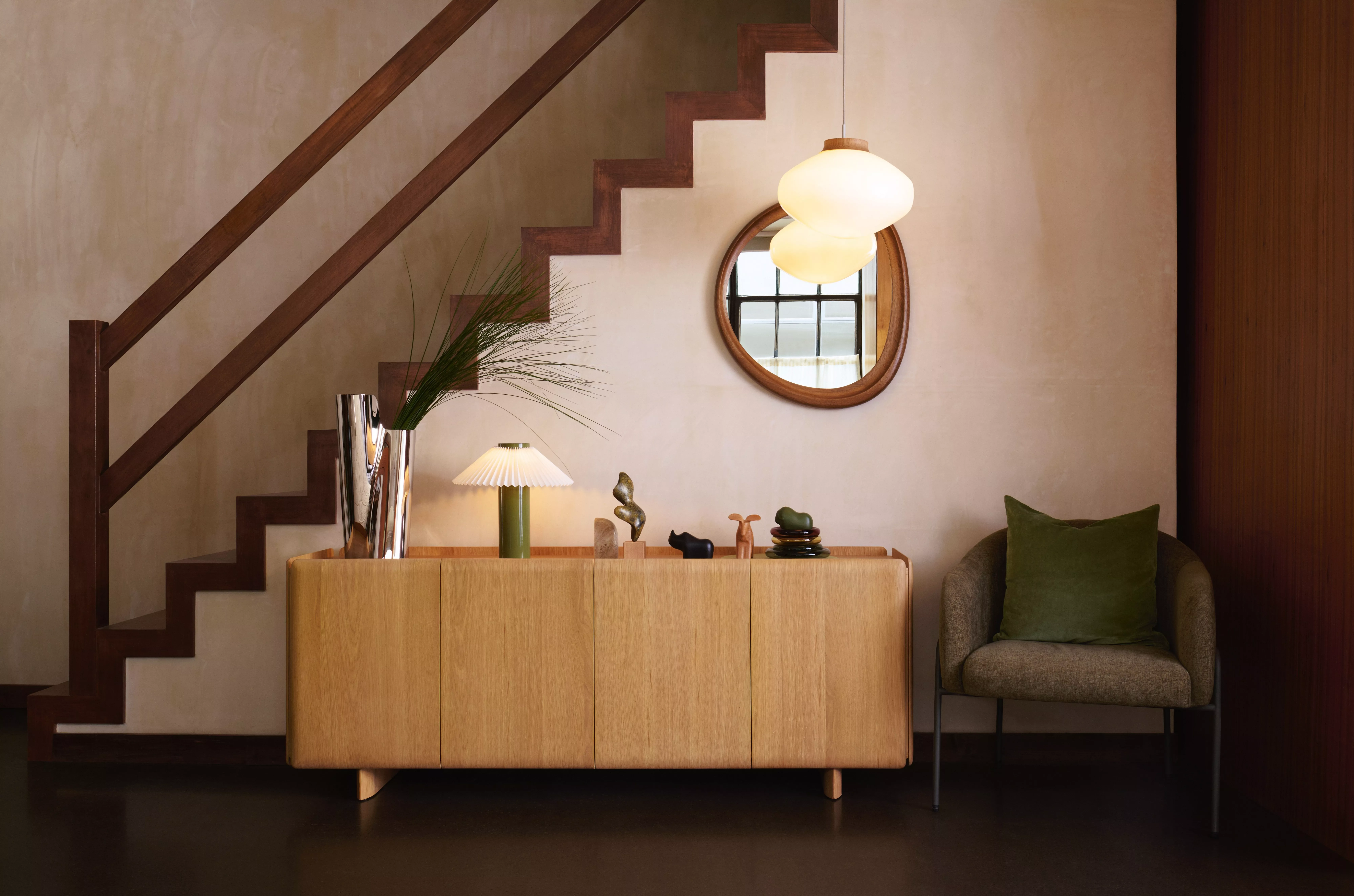 Modern interior with patterned curtains, a leather chair, and a stylish side table. Soft light enhances textures.