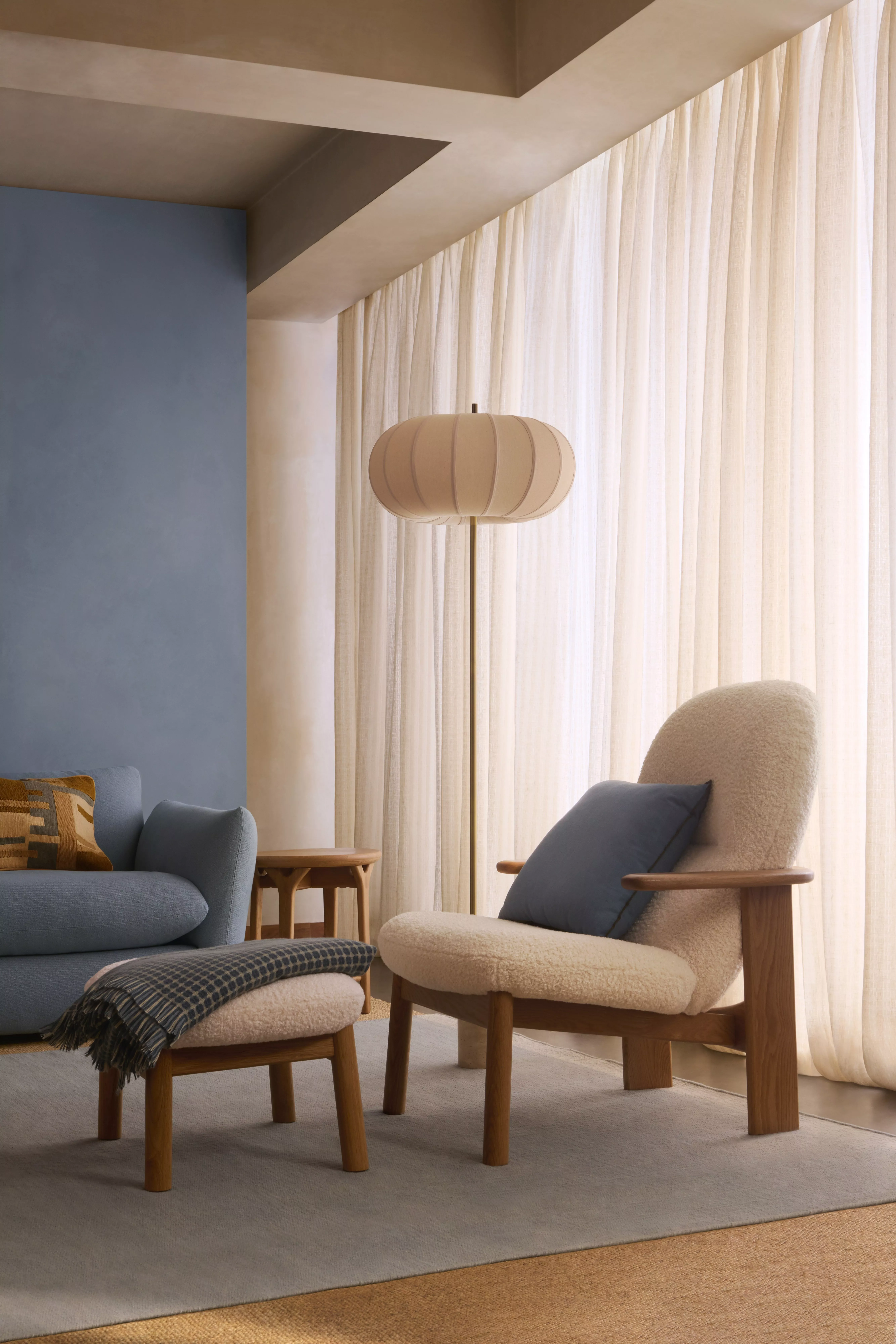 Green armchair in front of an open window