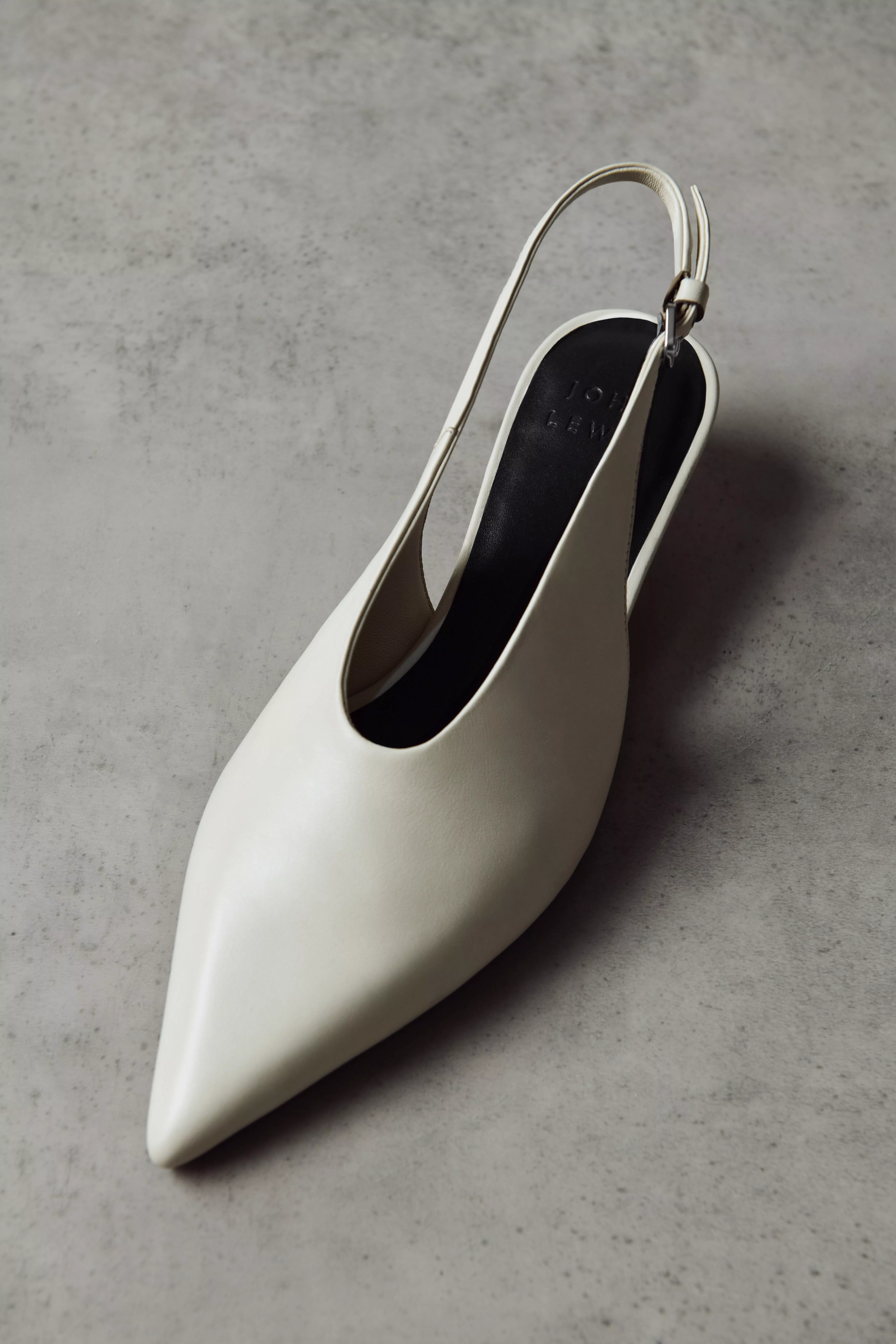 A white pointed toe slingback court shoe