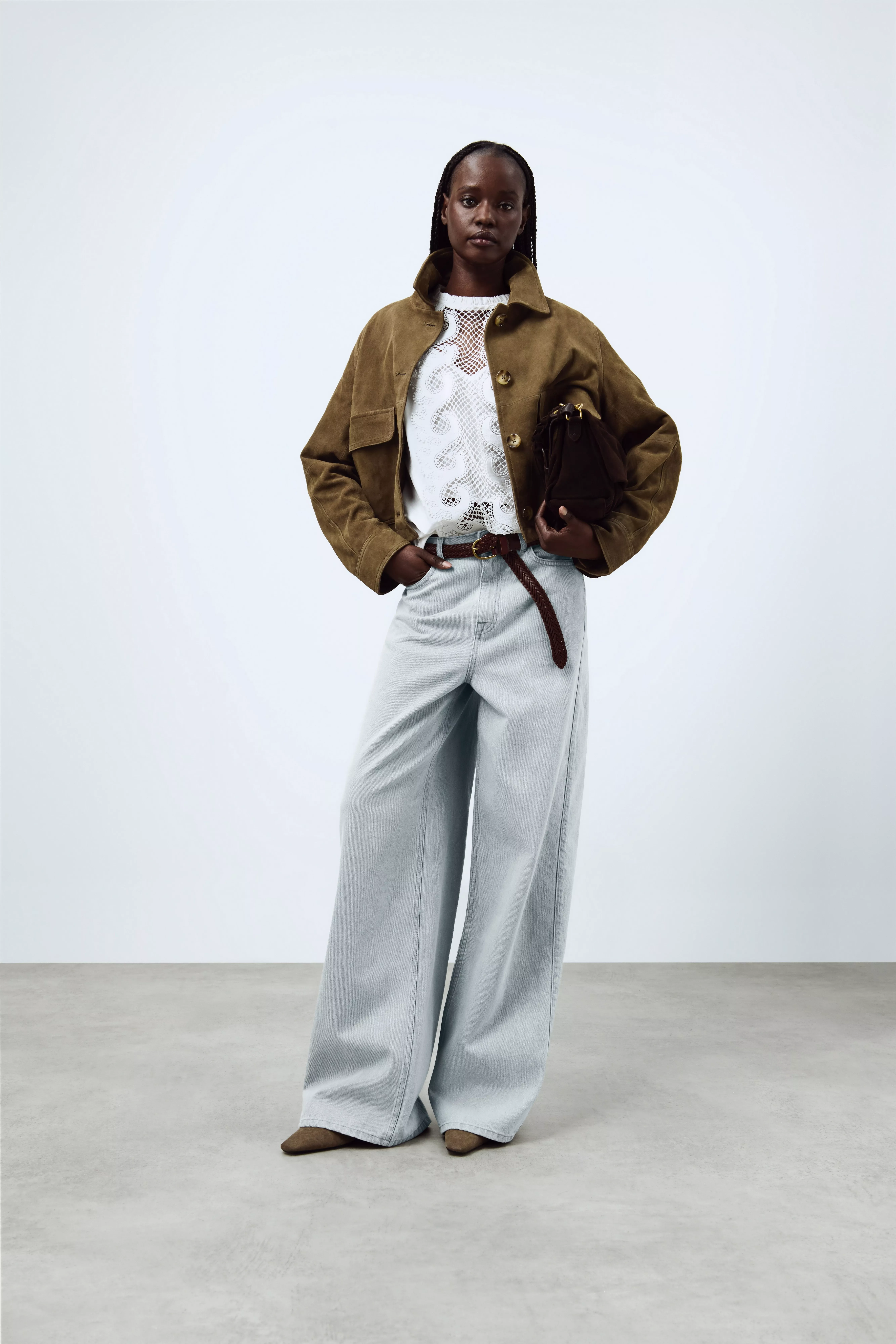 woman wearing a white lace blouse with jacket and jeans
