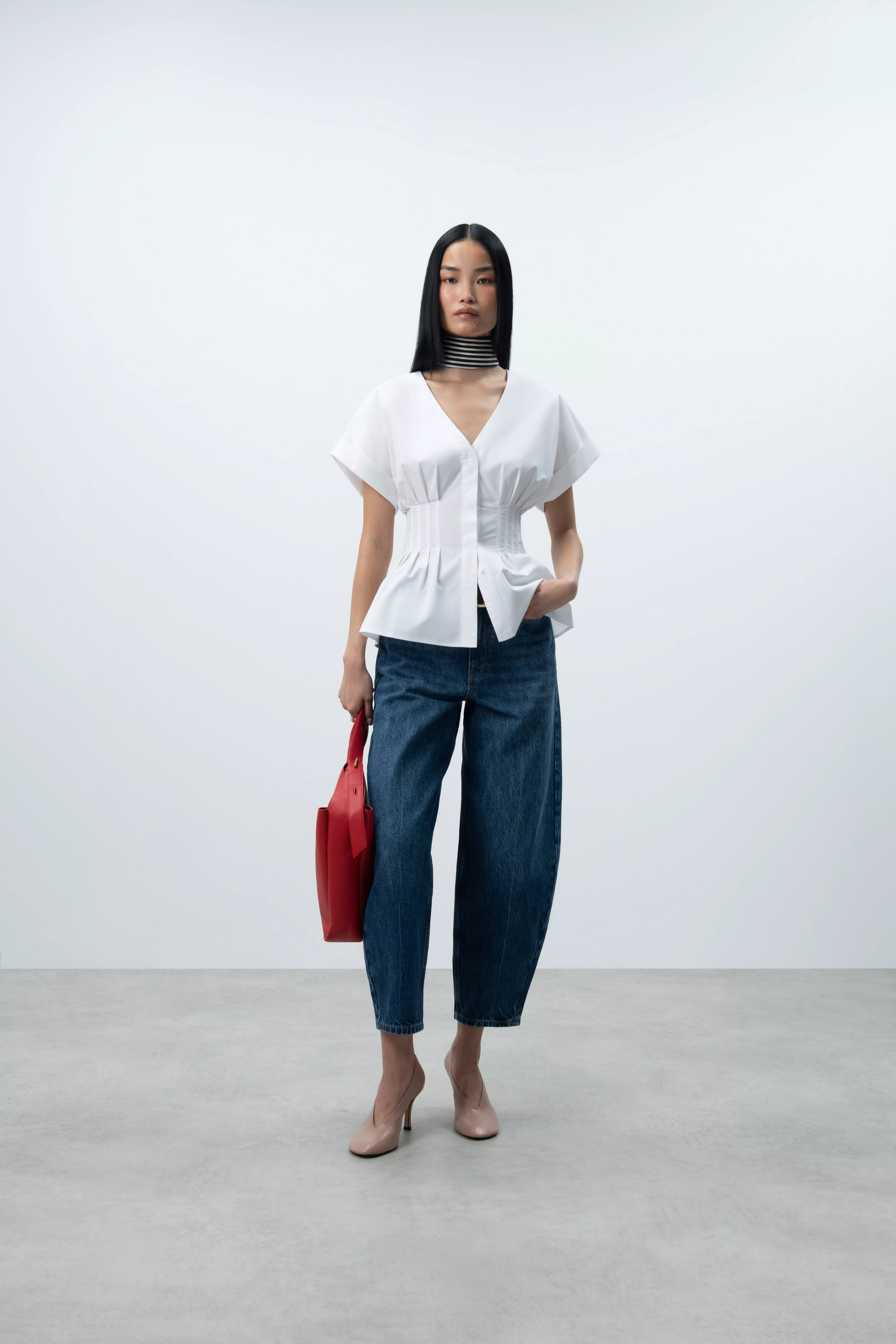 woman wearing a white lace blouse and jeans