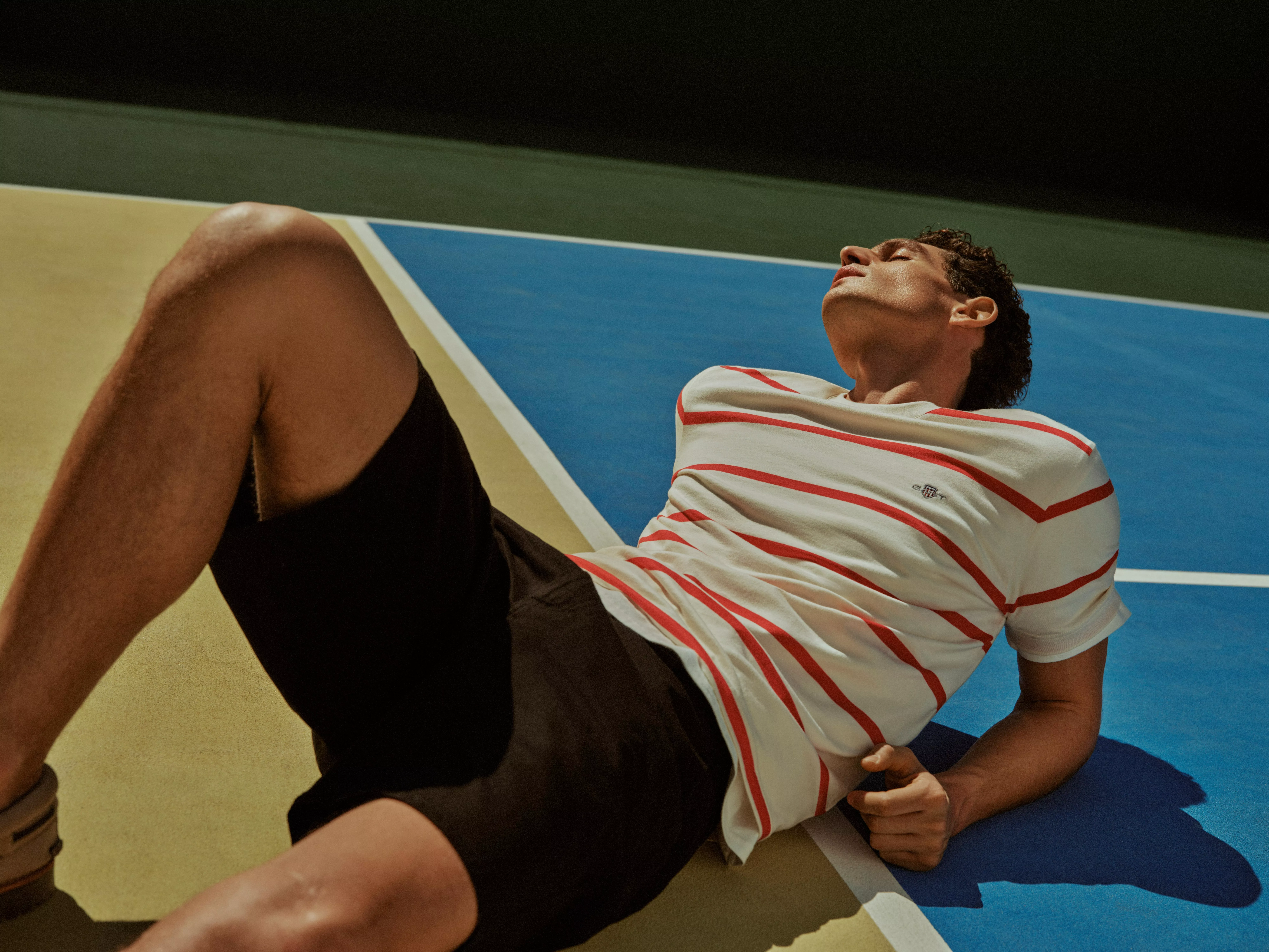 Man wearing a striped red and white t-shirt with shorts