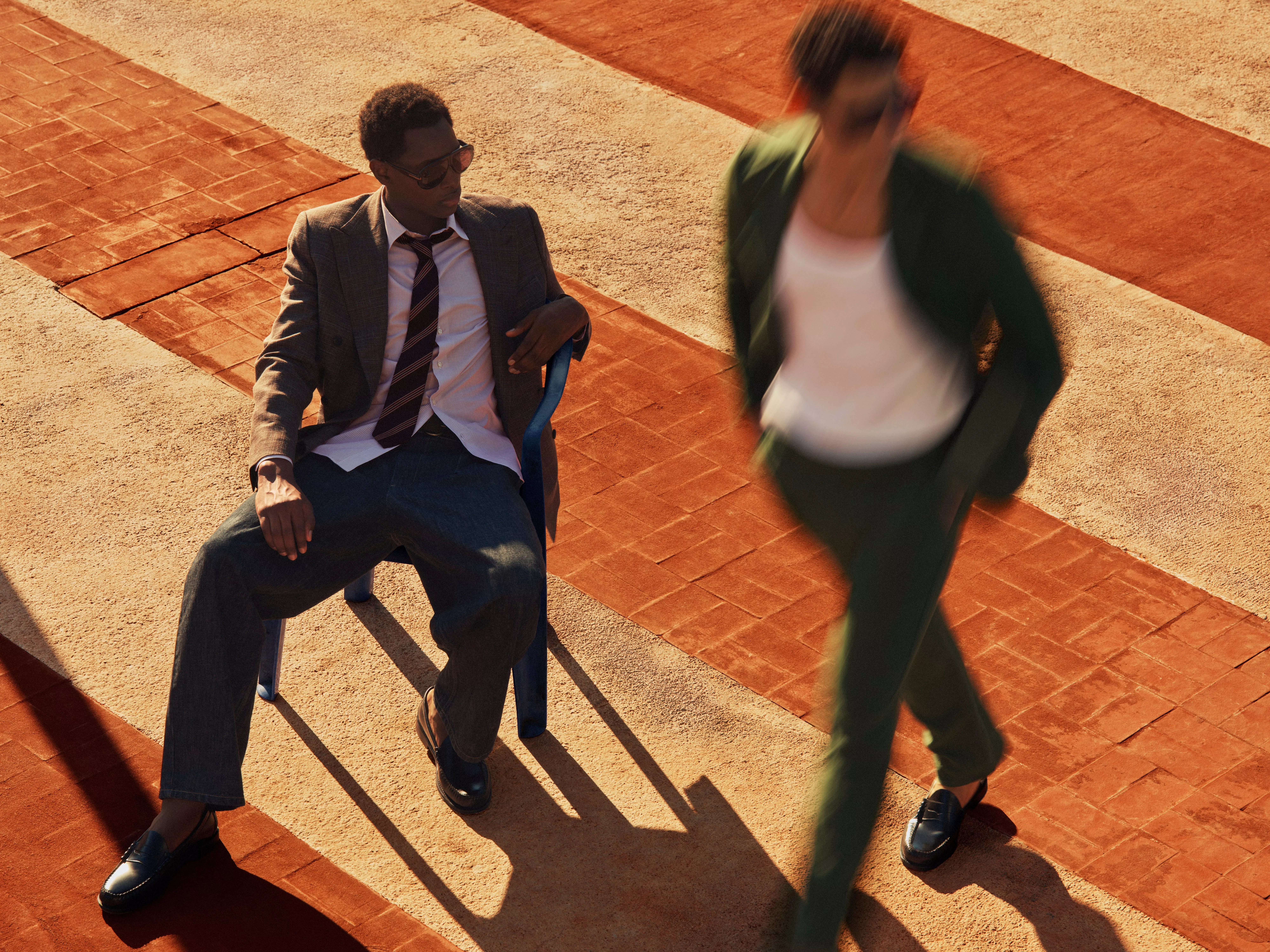 Man sitting in a chair wearing a pair of dark blue jeans