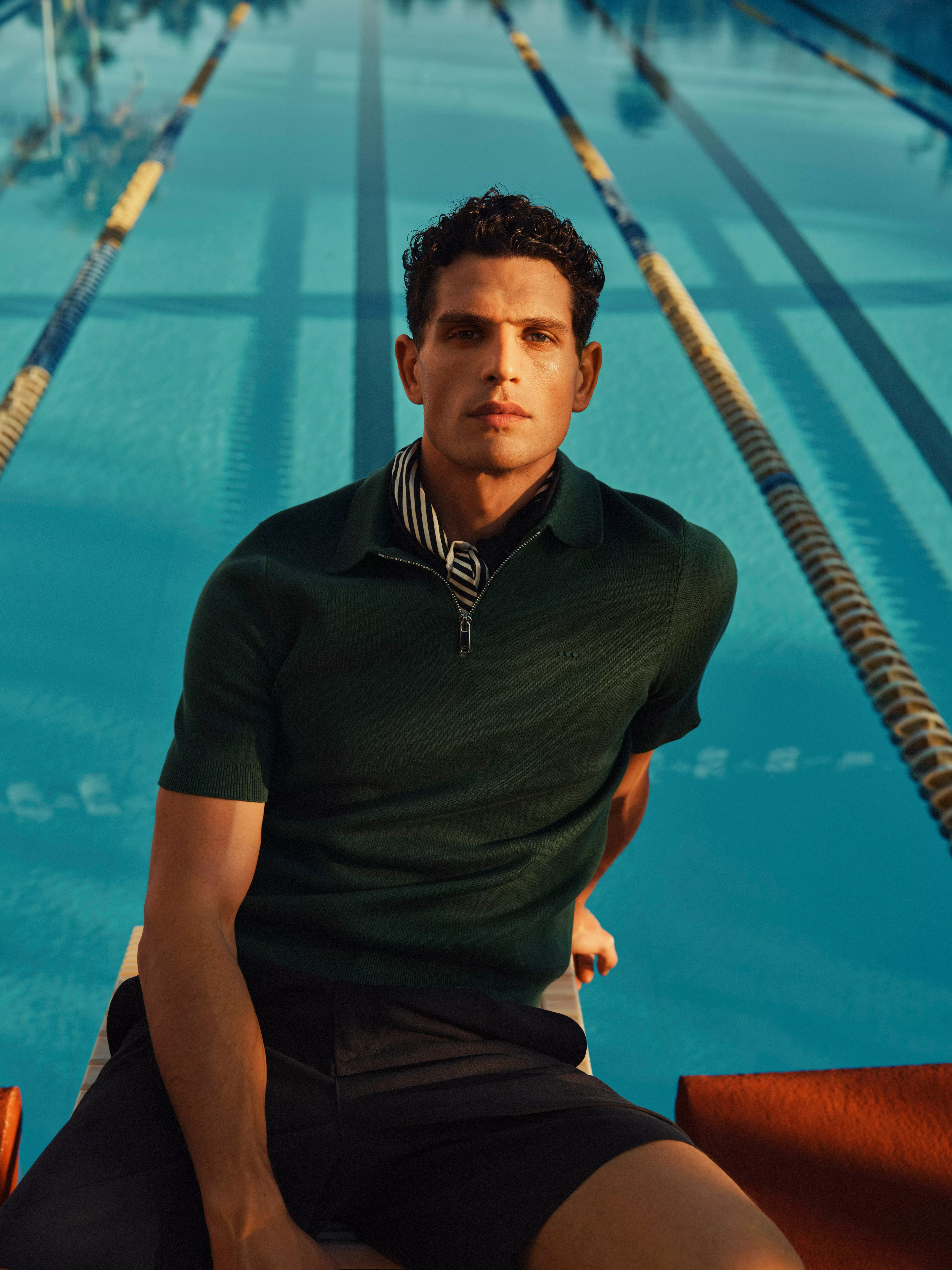 Man wearing a green polo shirt with shorts